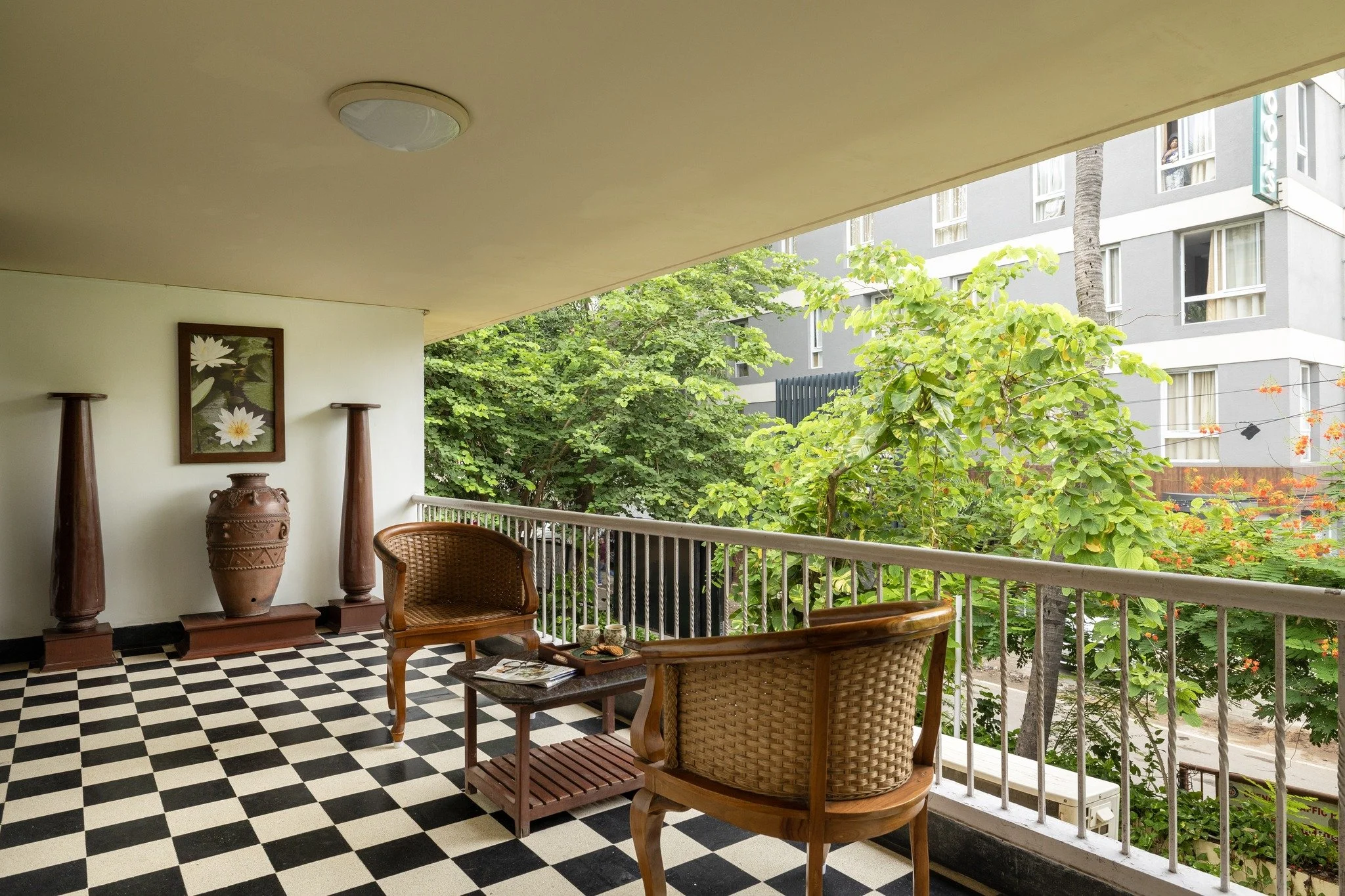 This is what slowing down actually looks like. 🌿

A verandah, two chairs, greenery right outside, and nothing demanding your attention. This is the kind of space Hanu Reddy Residences is built around&mdash;heritage charm, open air, and a calm that y