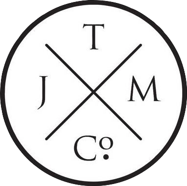 A circular logo with intersecting lines dividing it into four sections, each containing a letter: J, T, M, C.