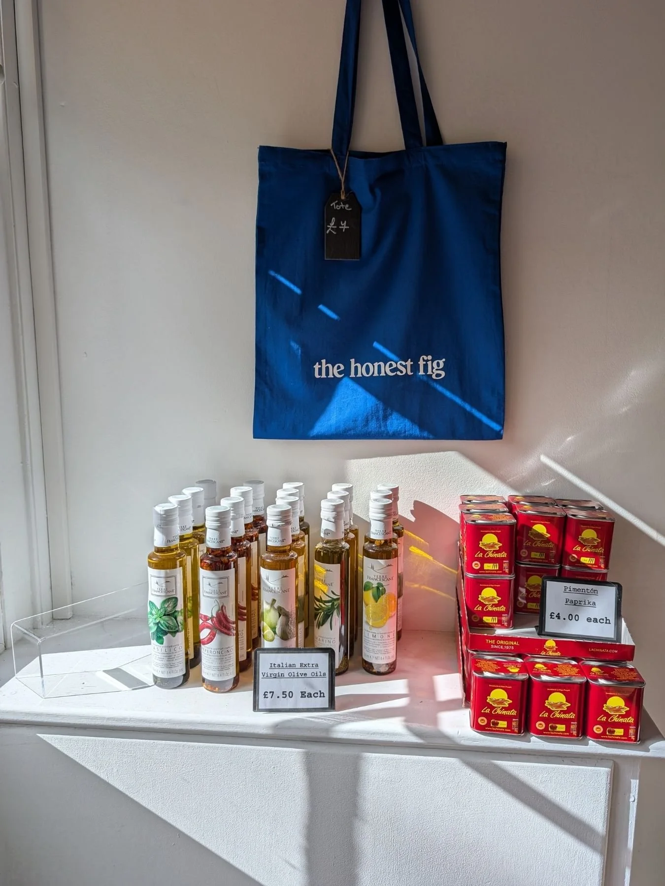 Image in the shop, a tote bag, olive oil and paprika.