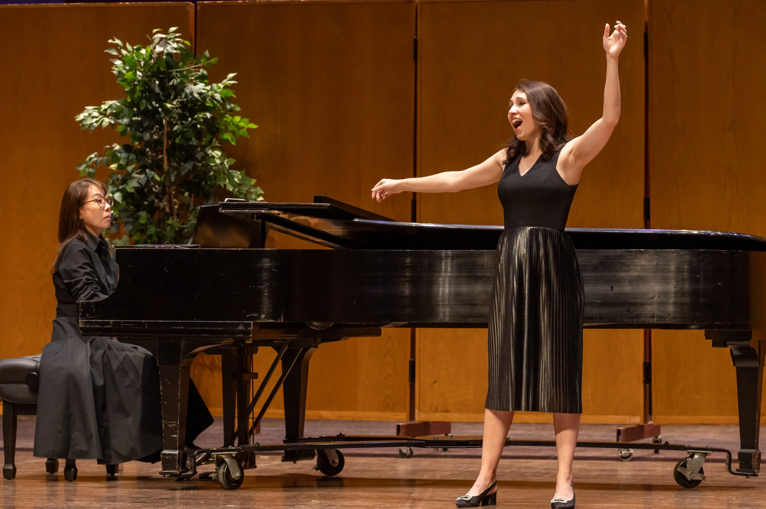 opera singer on stage in front of a piano