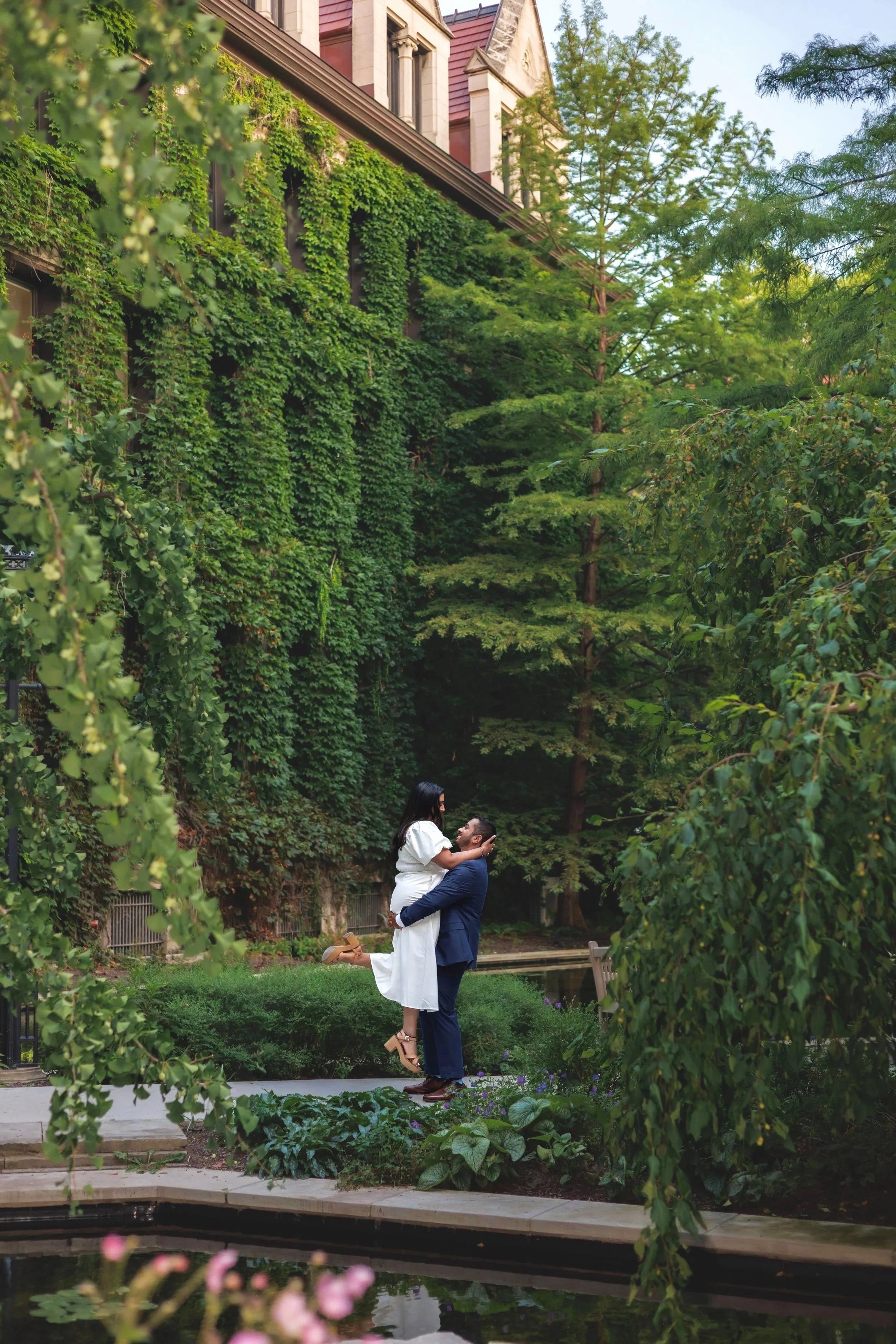 A man in a blue suit kneeling and proposing to a woman in a blue dress, with St. Louis Cathedral in the background, New Orleans.