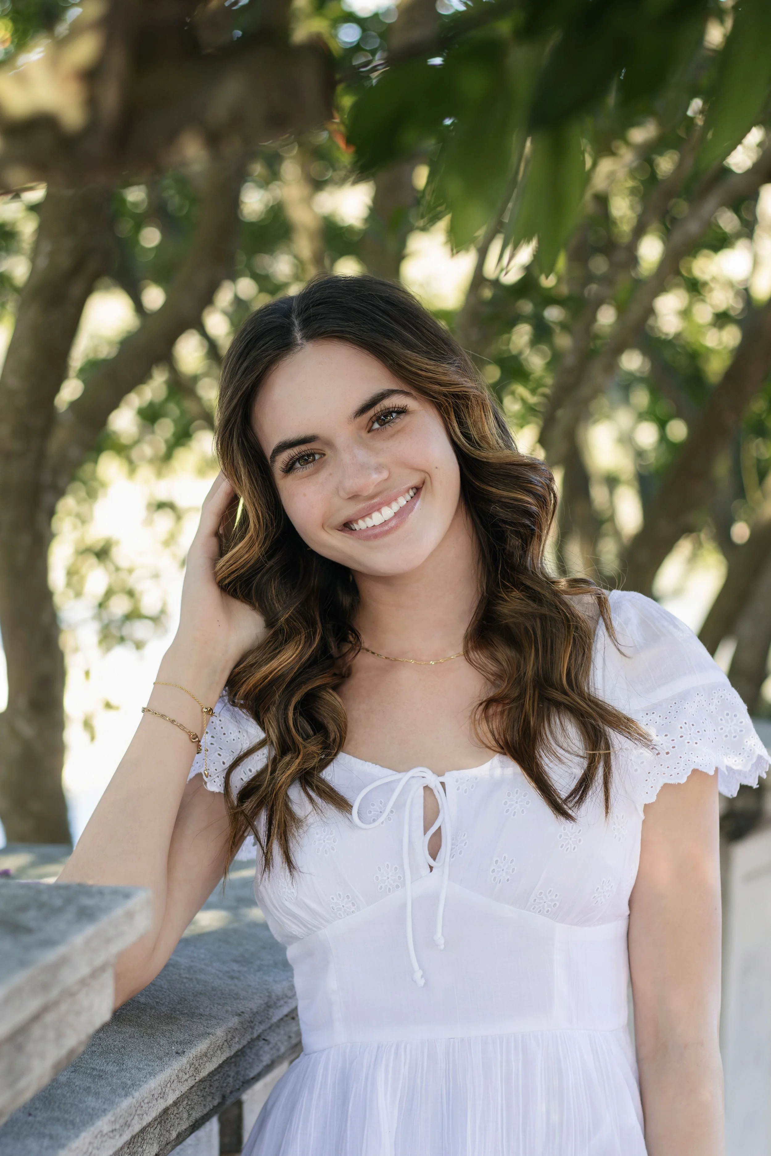Person in pink dress smiling in a canoe on a lake.