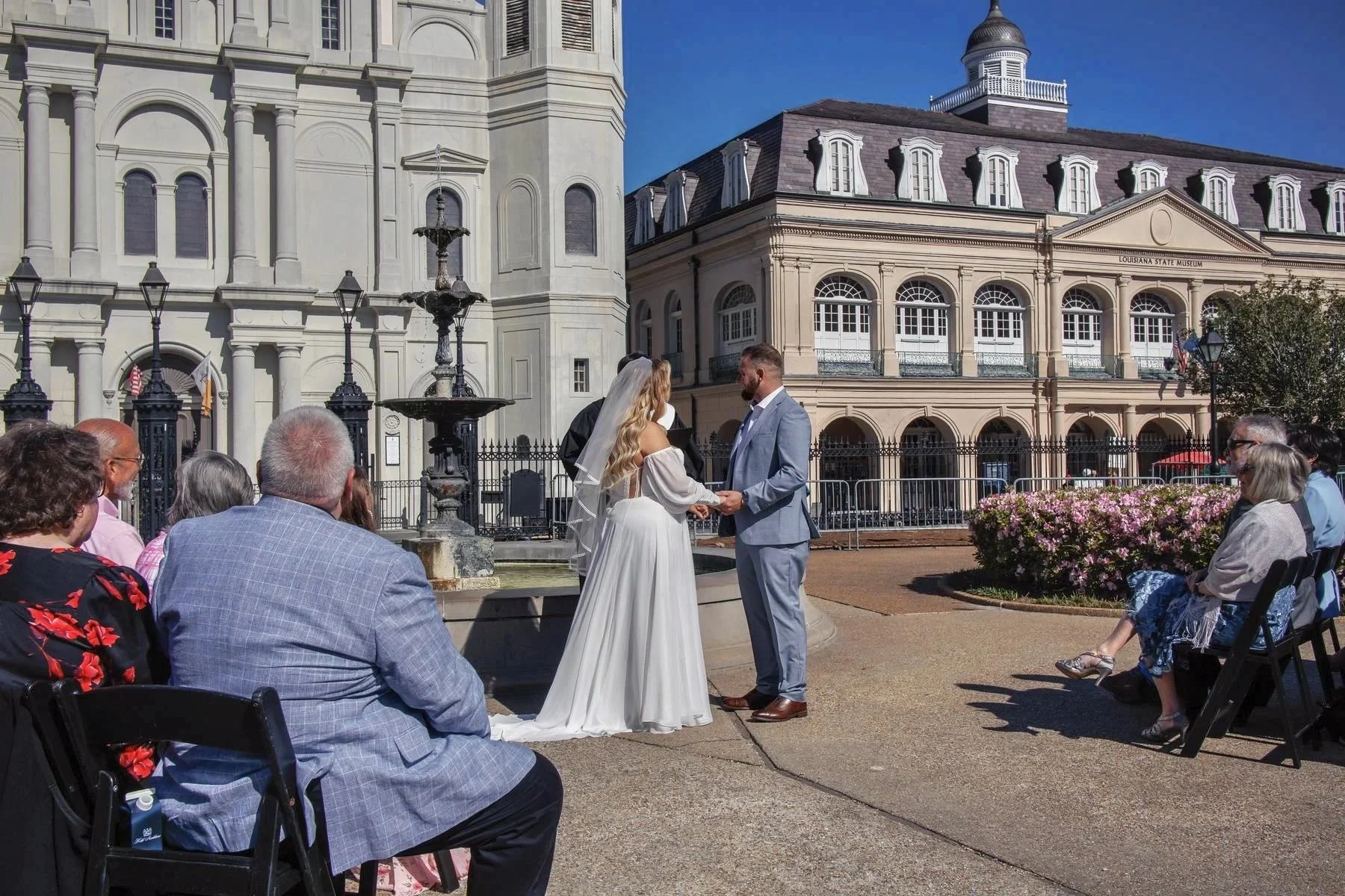 New Orleans wedding photographer capturing a couple exchanging vows in Jackson Square in front of St. Louis Cathedral, romantic and iconic outdoor ceremony