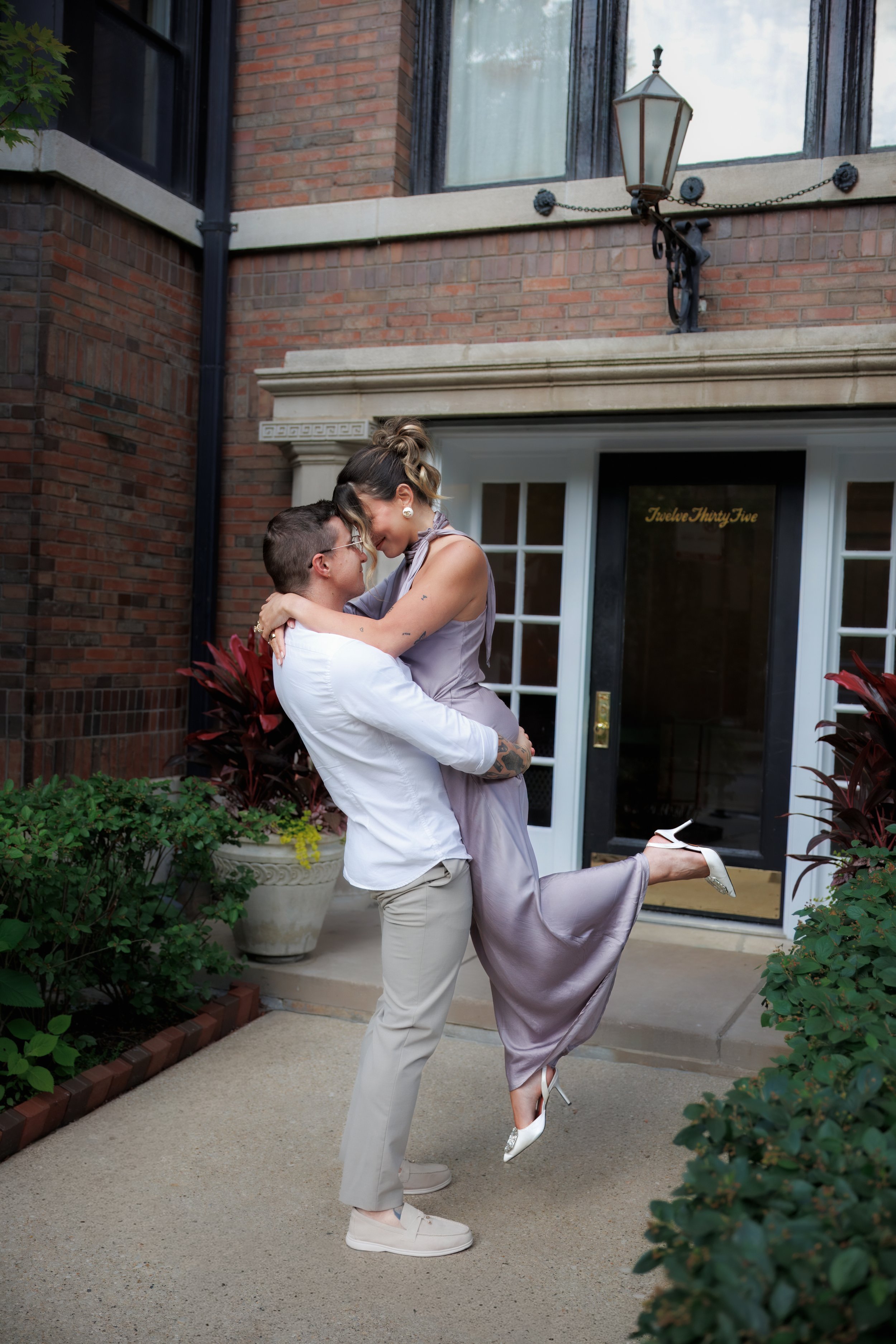Elegant engagement couple in a lifted embrace at a Chicago engagement photo session.