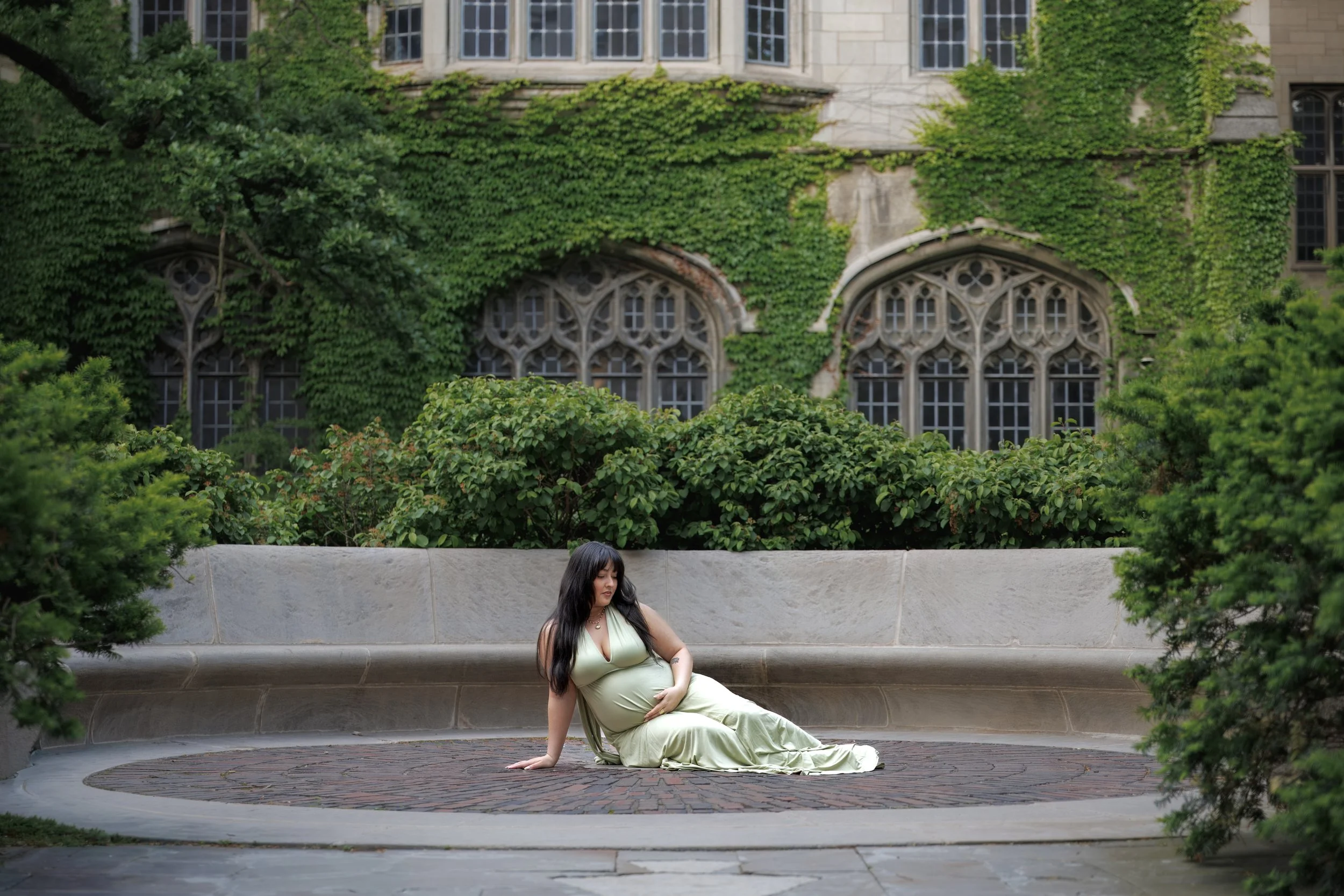 Chicago maternity photographer capturing an artistic photo with a  women's hands resting on a baby bump, soft light and emotional connection
