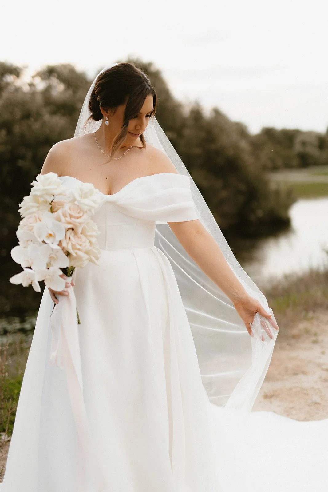 Our Bride Danielle wearing her custom heirloom wedding veil. Featuring her mother's bridal veil's embroidery and modern pearls.

Taylah Jayde Photography 