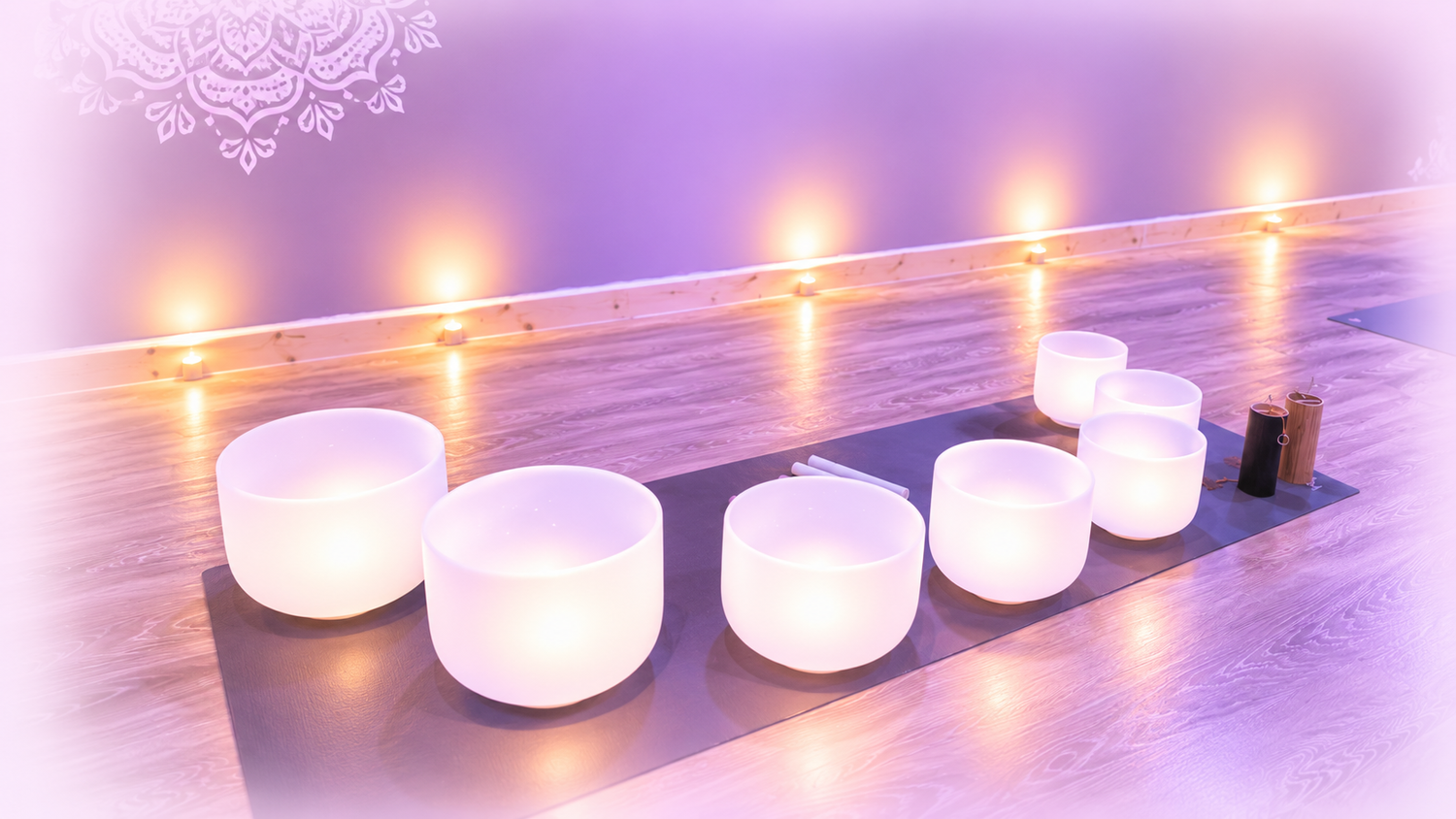 Luminous crystal singing bowls in a softly lit lavender sound healing studio