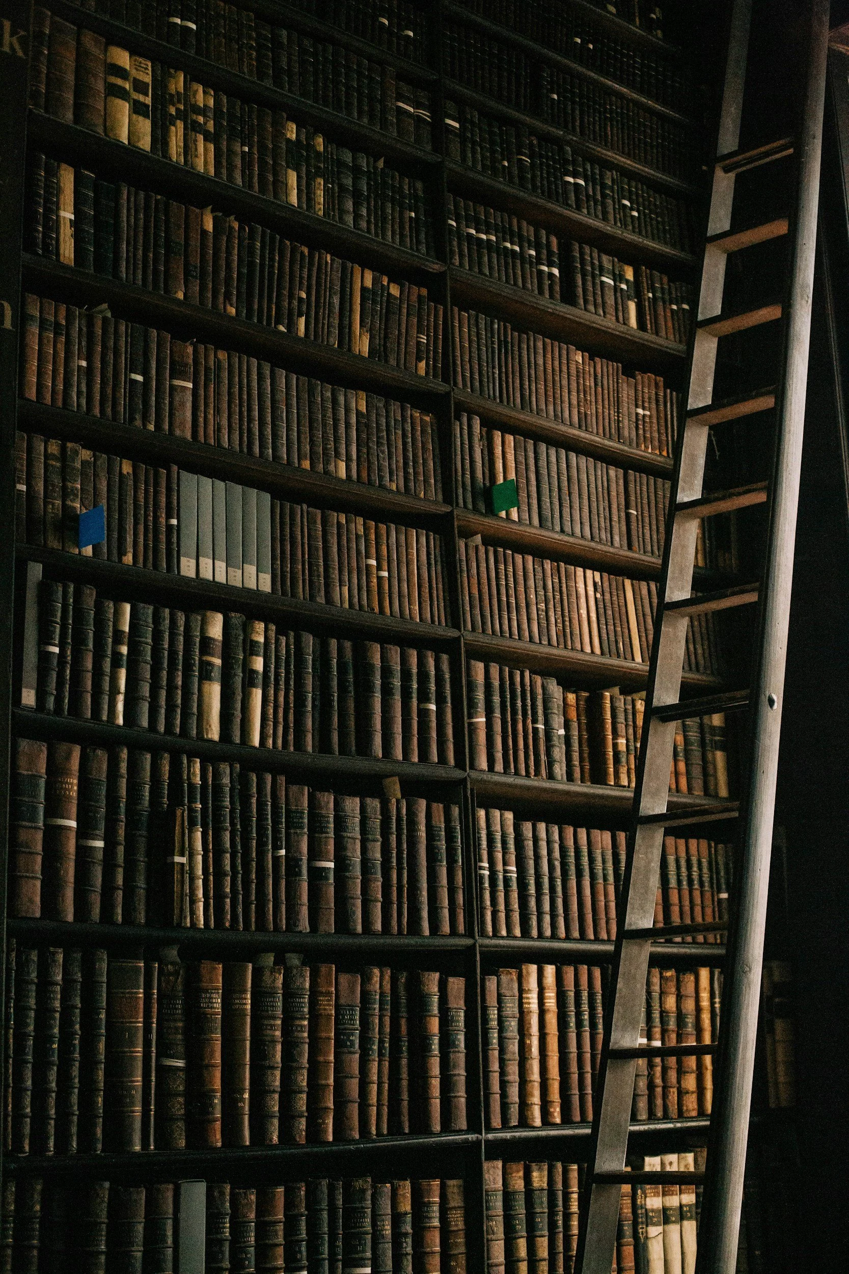 A close-up of an open book or notebook resting on a dark textured surface.