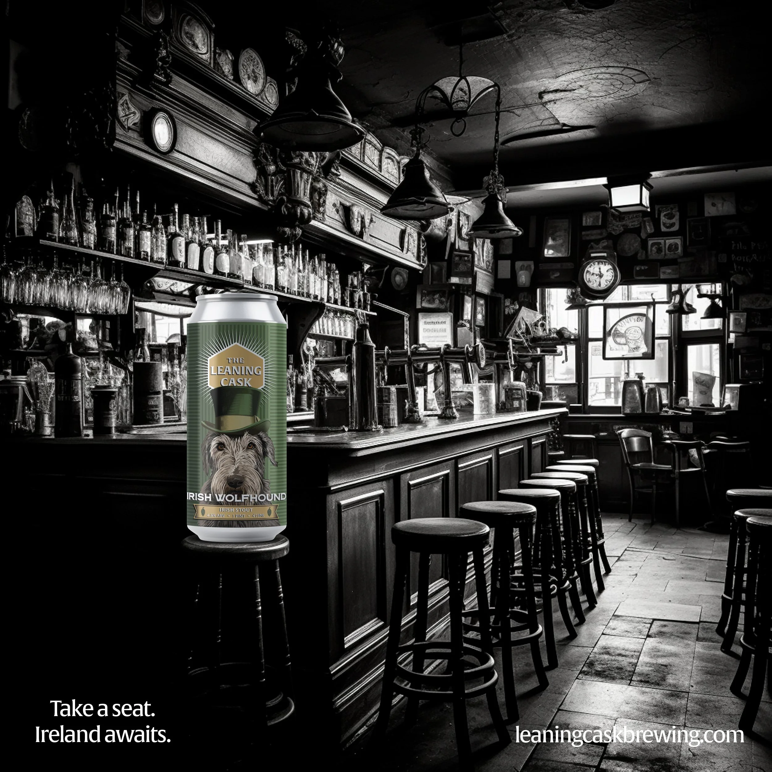 A monochrome image of a traditional pub interior with a long wooden bar, stools, and vintage decor. In the foreground, there is a color image of a can from The Leaning Cask Brewing Company with an Irish Wolfhound design. The text reads, "Take a seat. Ireland awaits." and the website "leaningcaskbrewing.com" is mentioned.