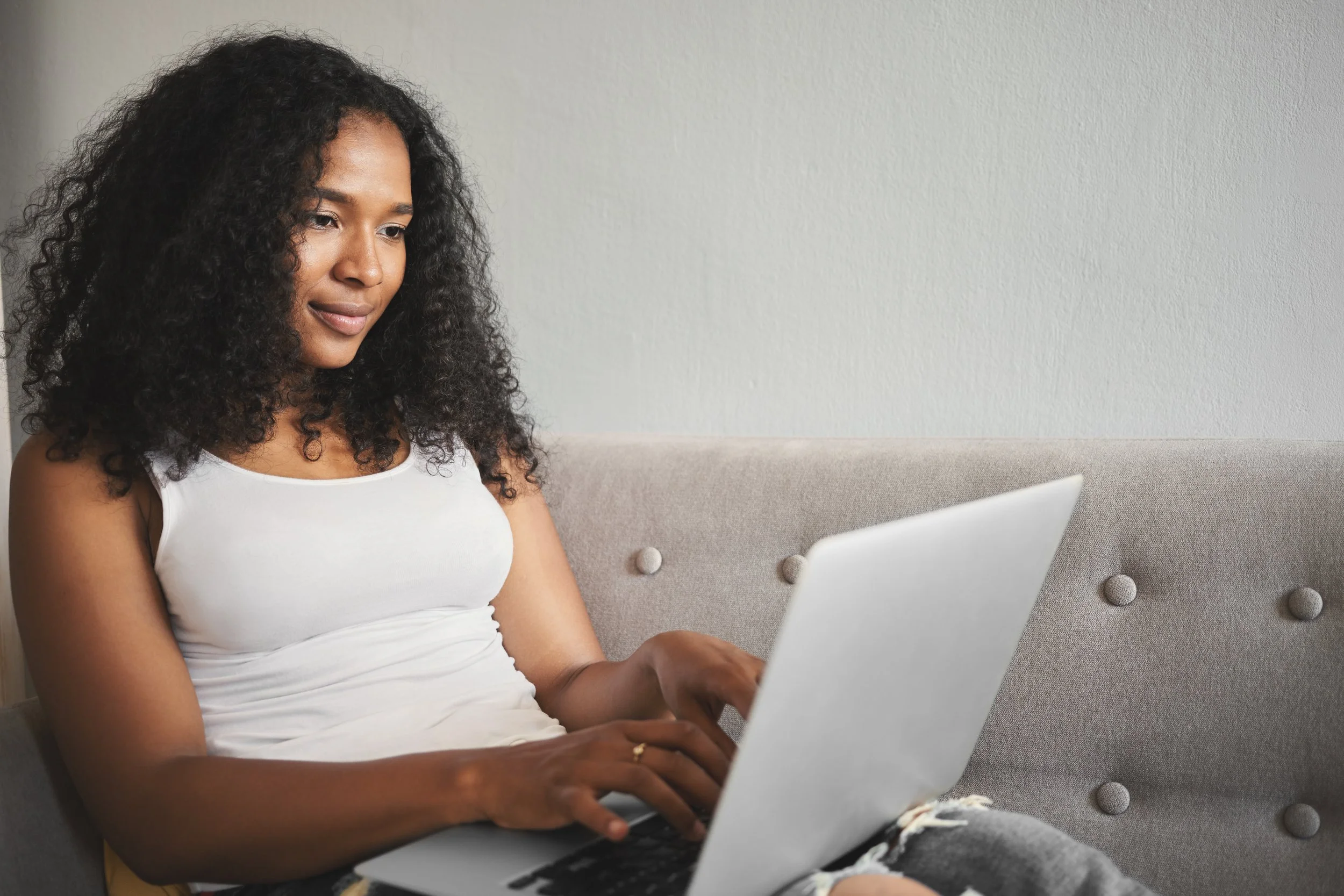 Founder running her business remotely from the couch after offloading inbox, calendar, and operations work.