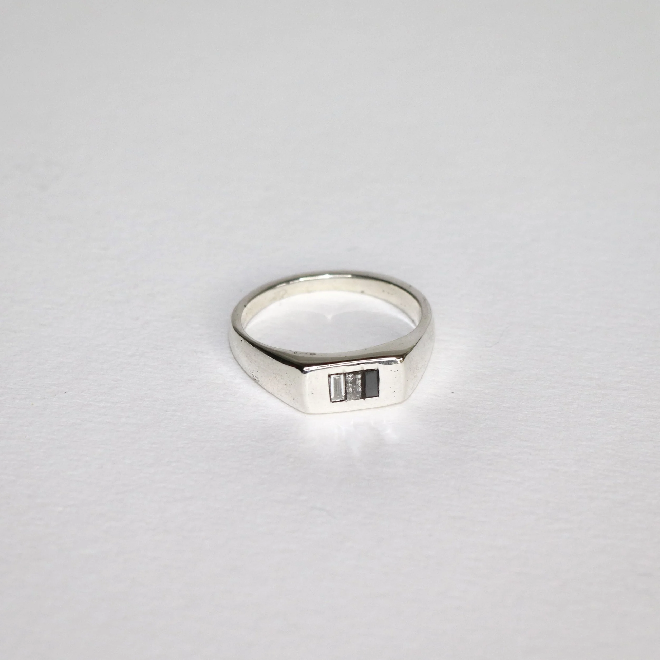 white gold signet. Black diamond white diamond.jpg
