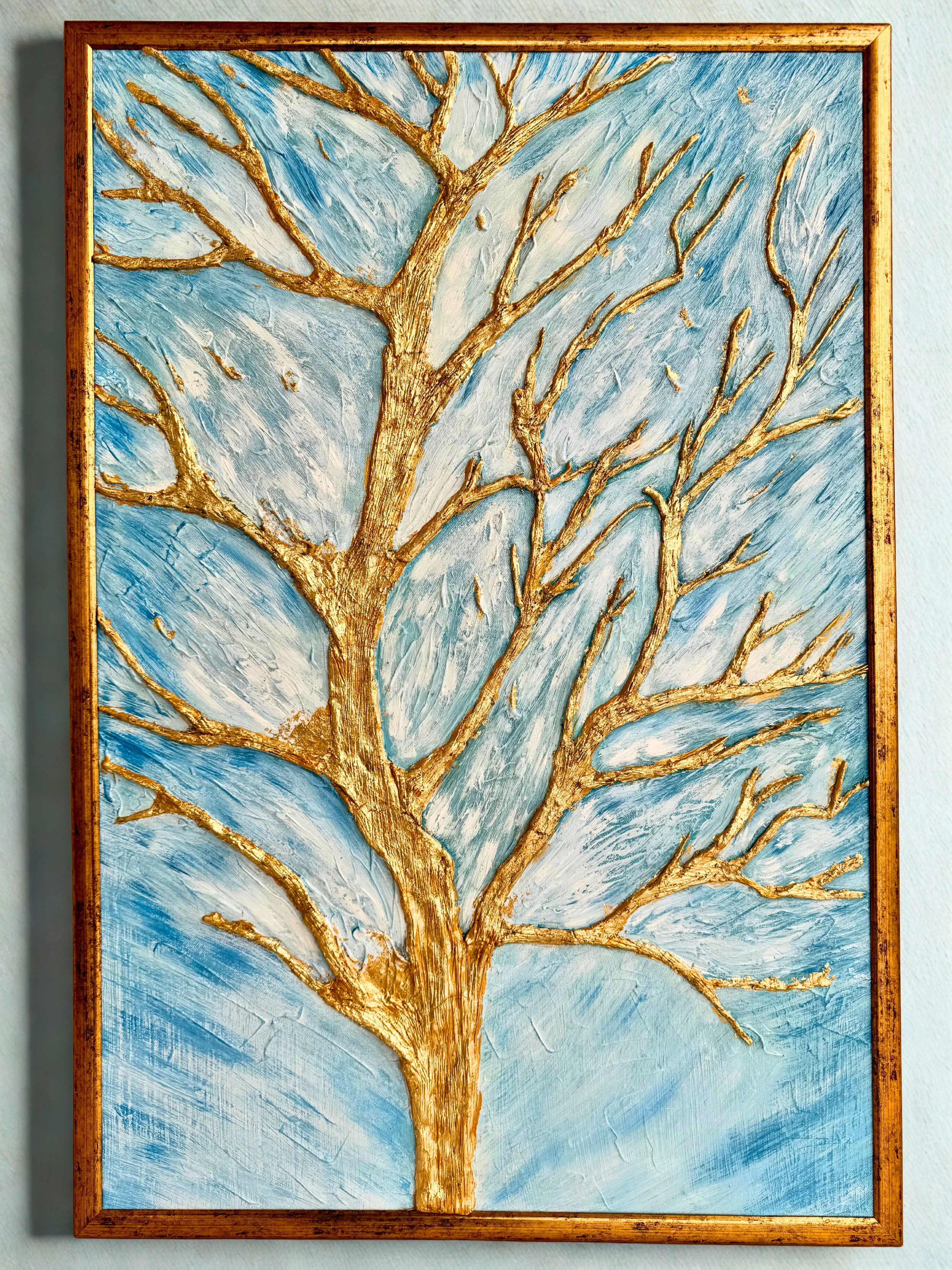 emotional symbolic artwork representing a moment of stillness through a gilden tree that resembles motherhood as it merges into a sky of quit movememt