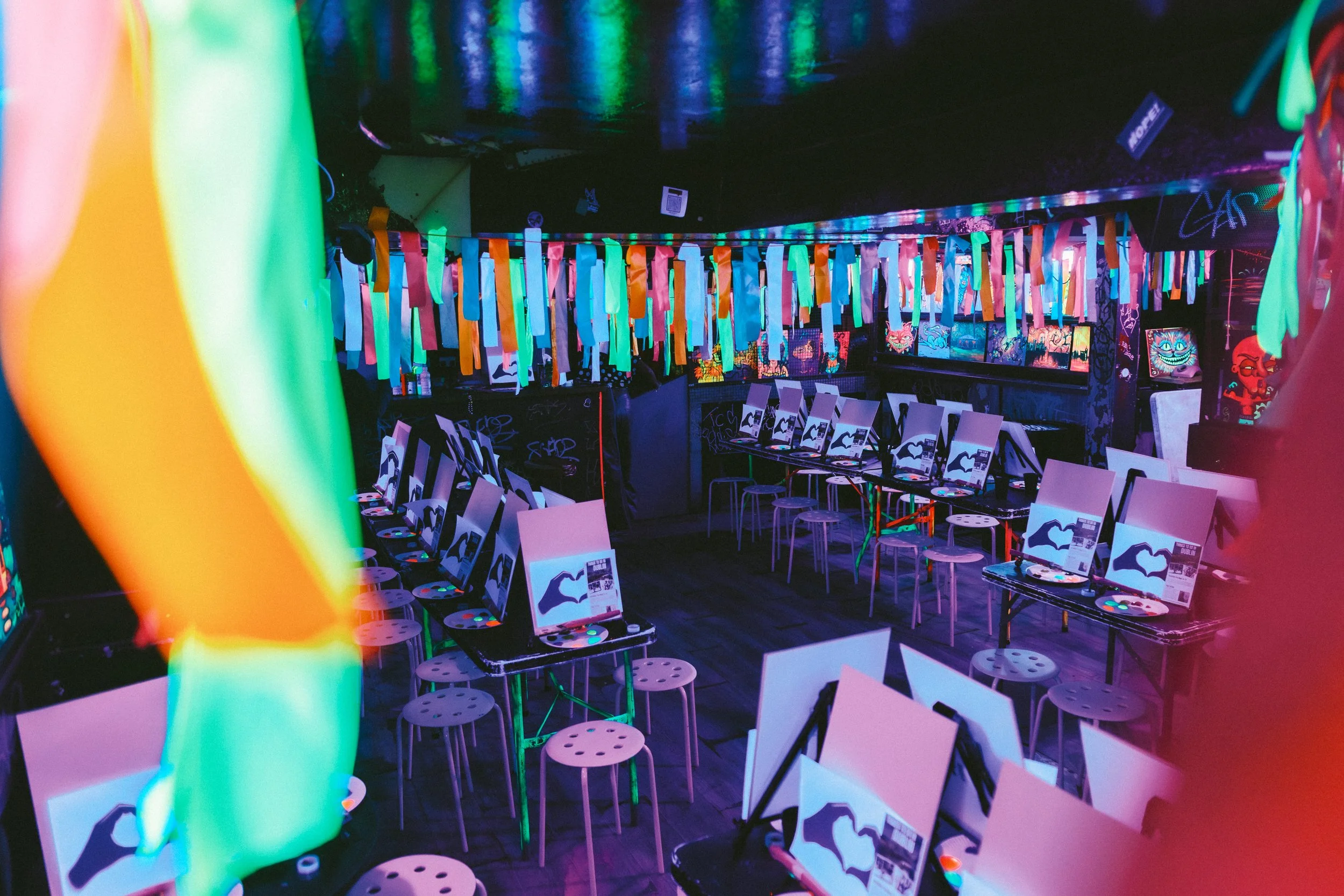 A man painting a smiley face in a paper dish.