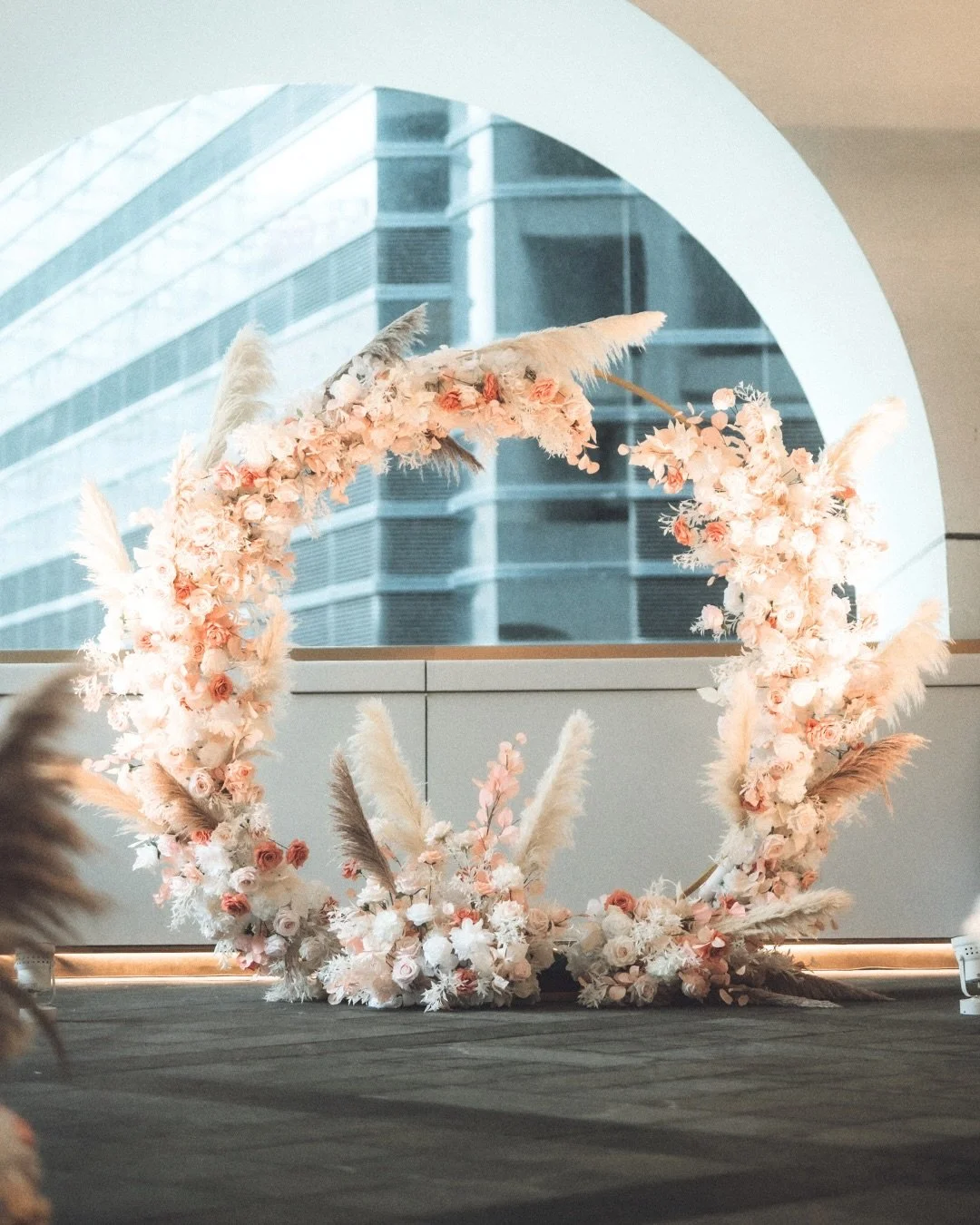 Wedding decoration for Jessie &amp; Kelvin 🤍

For this setup, we focused on clean lines, soft blush tones and texture 🤍 letting the florals frame the space without overpowering it. The circular floral arch was designed as the main visual anchor, pa