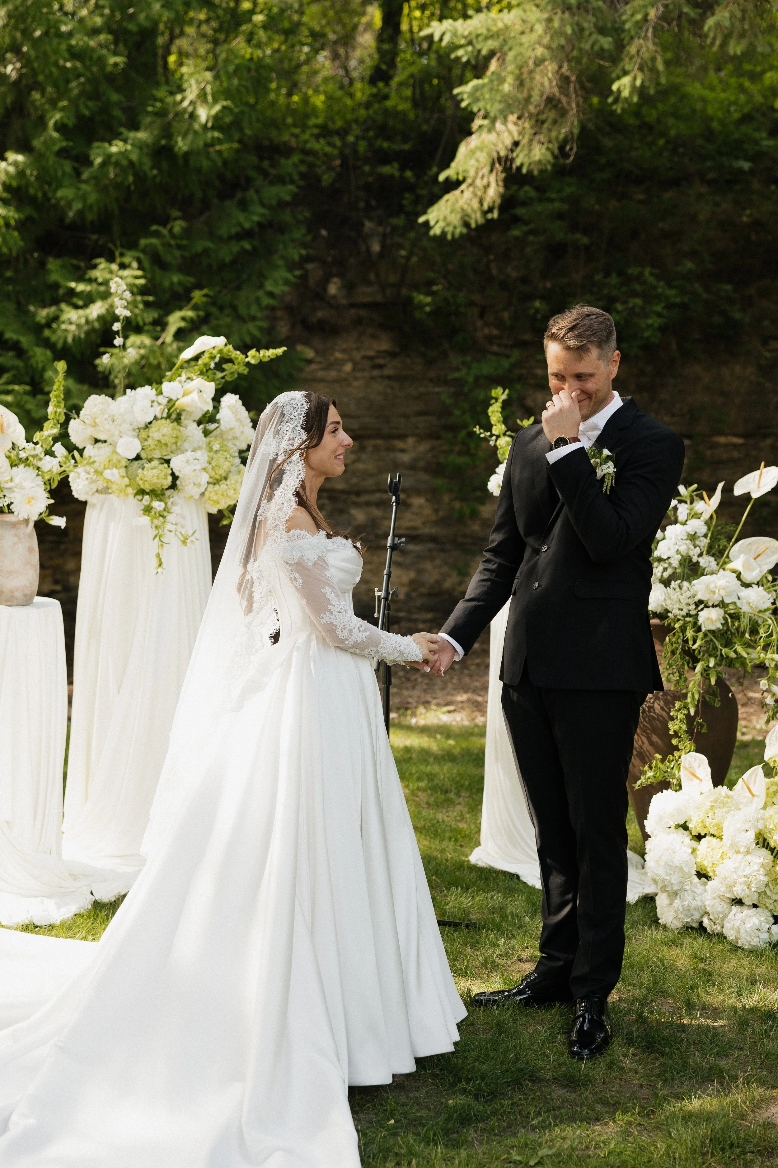 Romantic Rochester, MN wedding flowers featuring a modern white bridal bouquet, lush greenery, statement blooms, and garden-inspired ceremony florals.