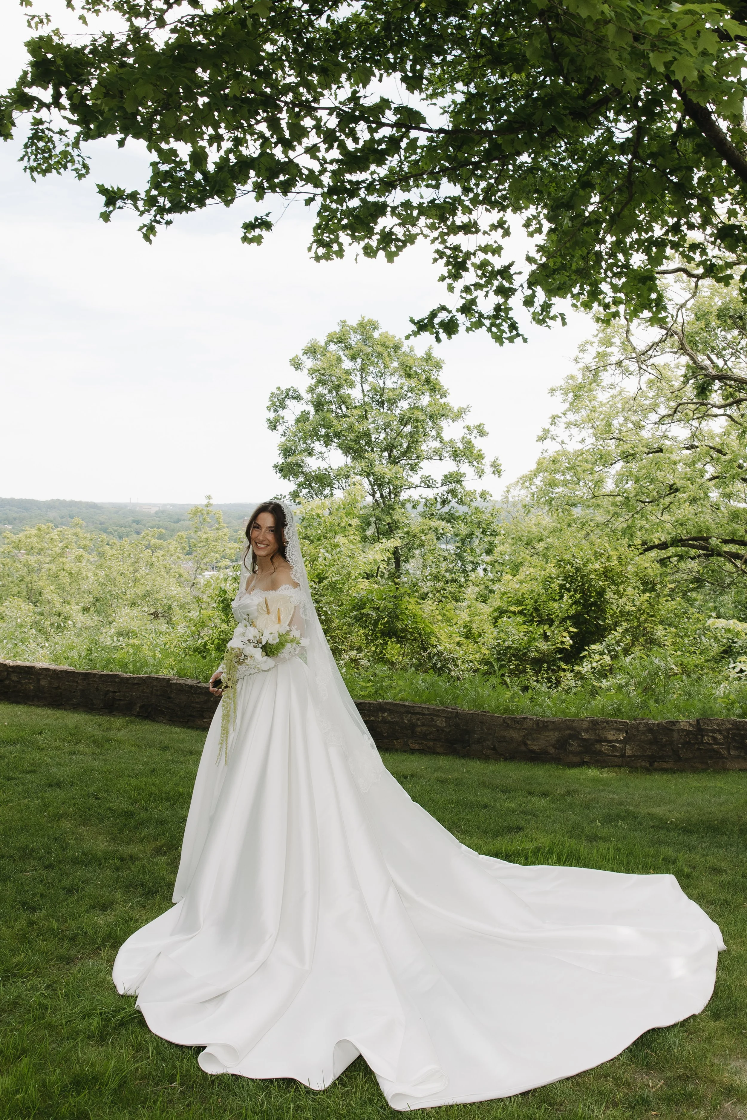 Romantic Rochester, MN wedding flowers featuring a modern white bridal bouquet, lush greenery, statement blooms, and garden-inspired ceremony florals.