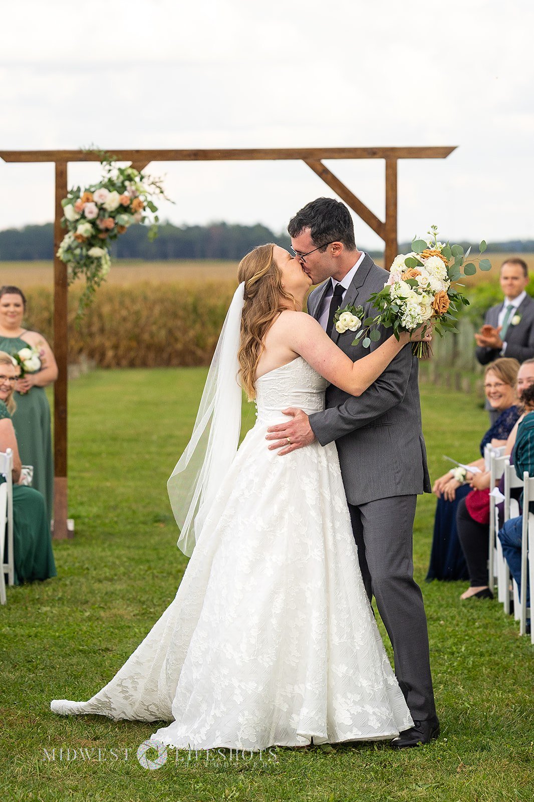 Romantic Spring Valley, MN wedding flowers screams quiet luxury - subtle statement florals on an arch at Four Daughter's Winery