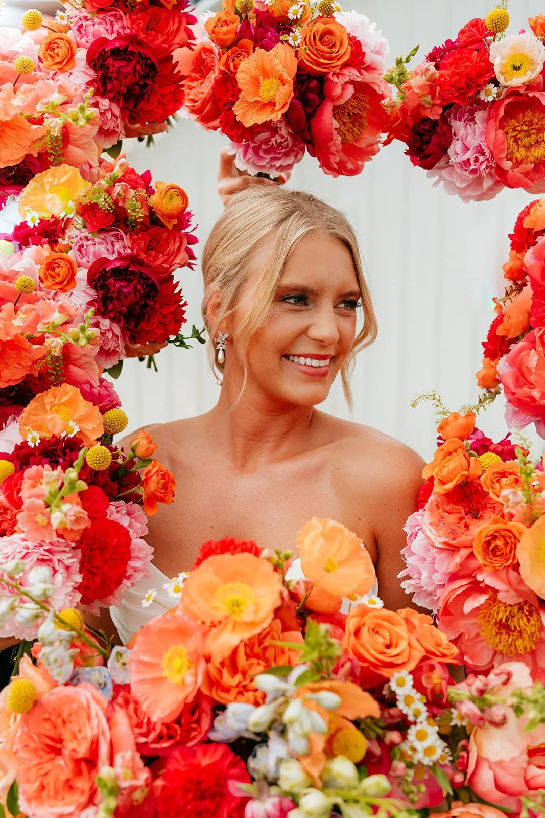 Vibrant coral, pink, and orange wedding flowers by Darling Block Floral in Rochester, MN.