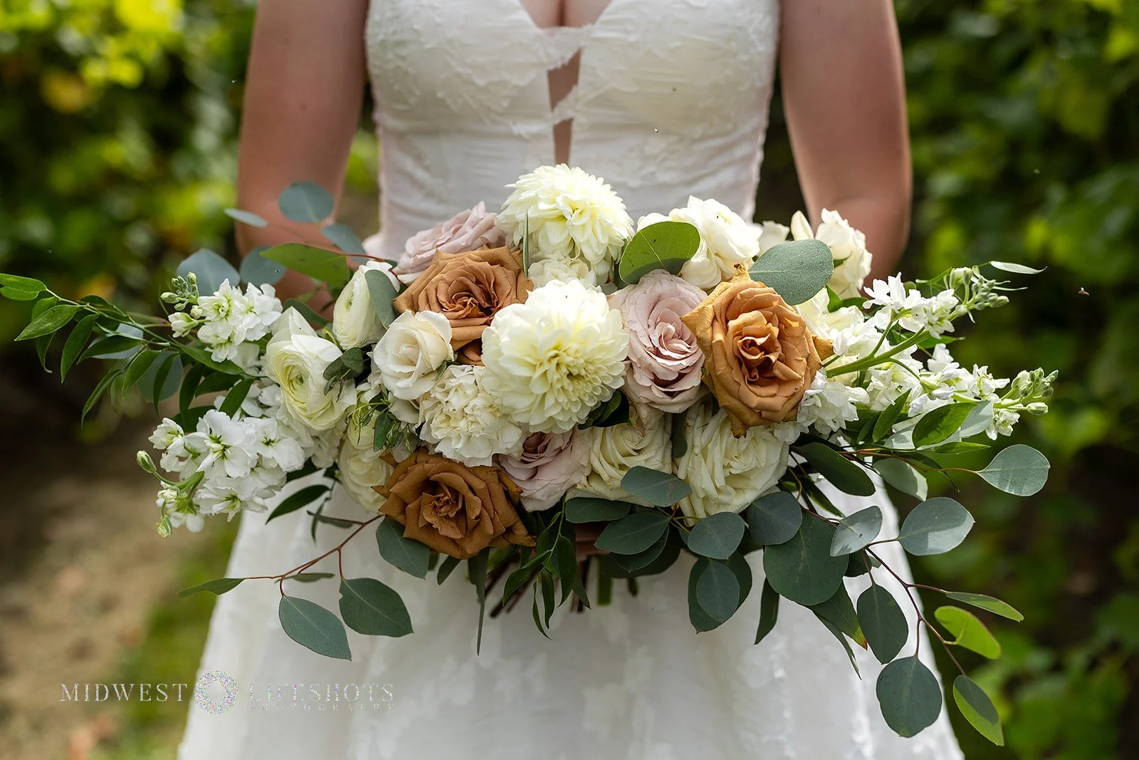 Romantic Spring Valley, MN wedding flowers featuring a modern white bridal bouquet, lush greenery, statement blooms, and garden-inspired wedding florals.
