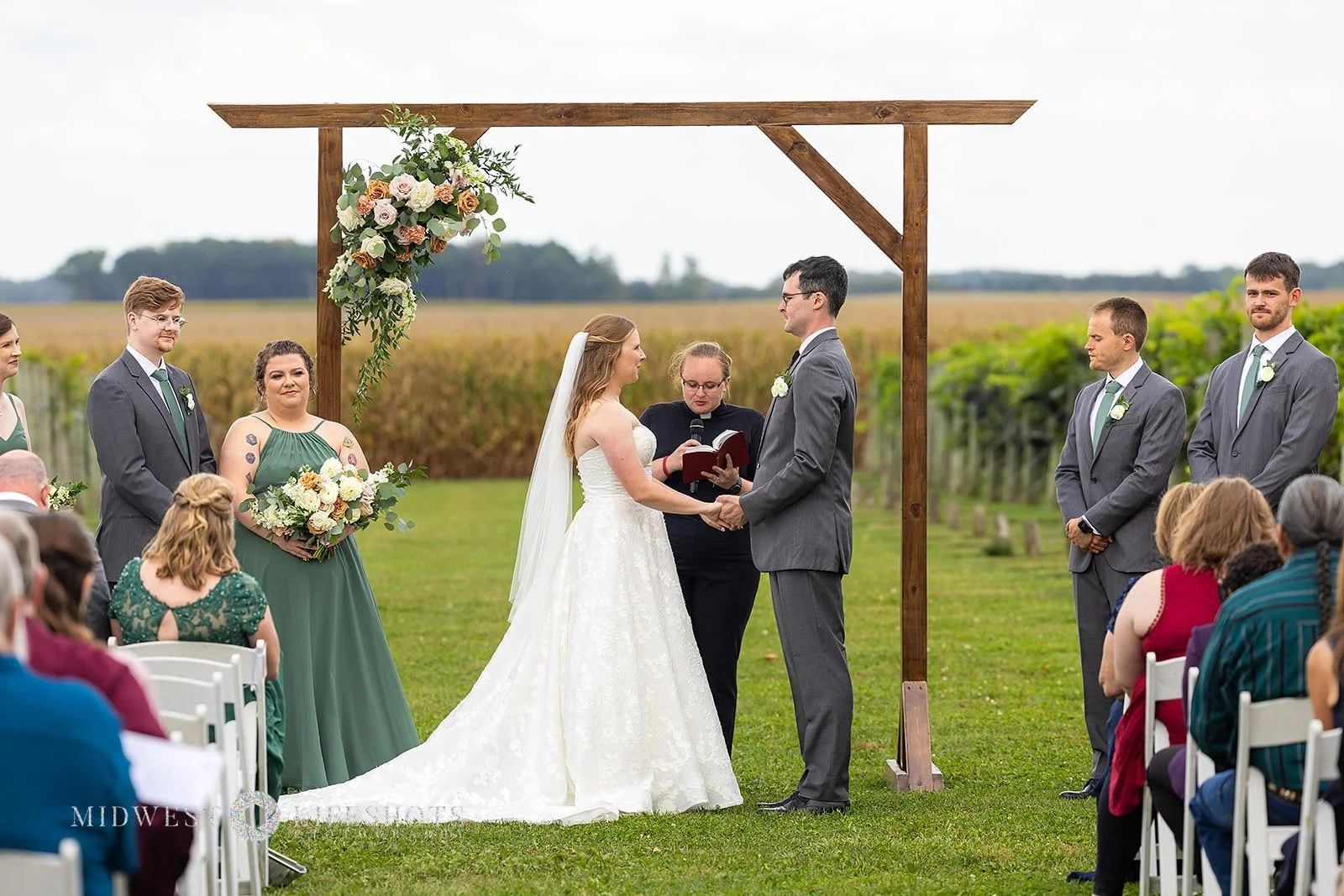 Romantic Spring Valley, MN wedding flowers screams quiet luxury - subtle statement florals on an arch at Four Daughter's Winery