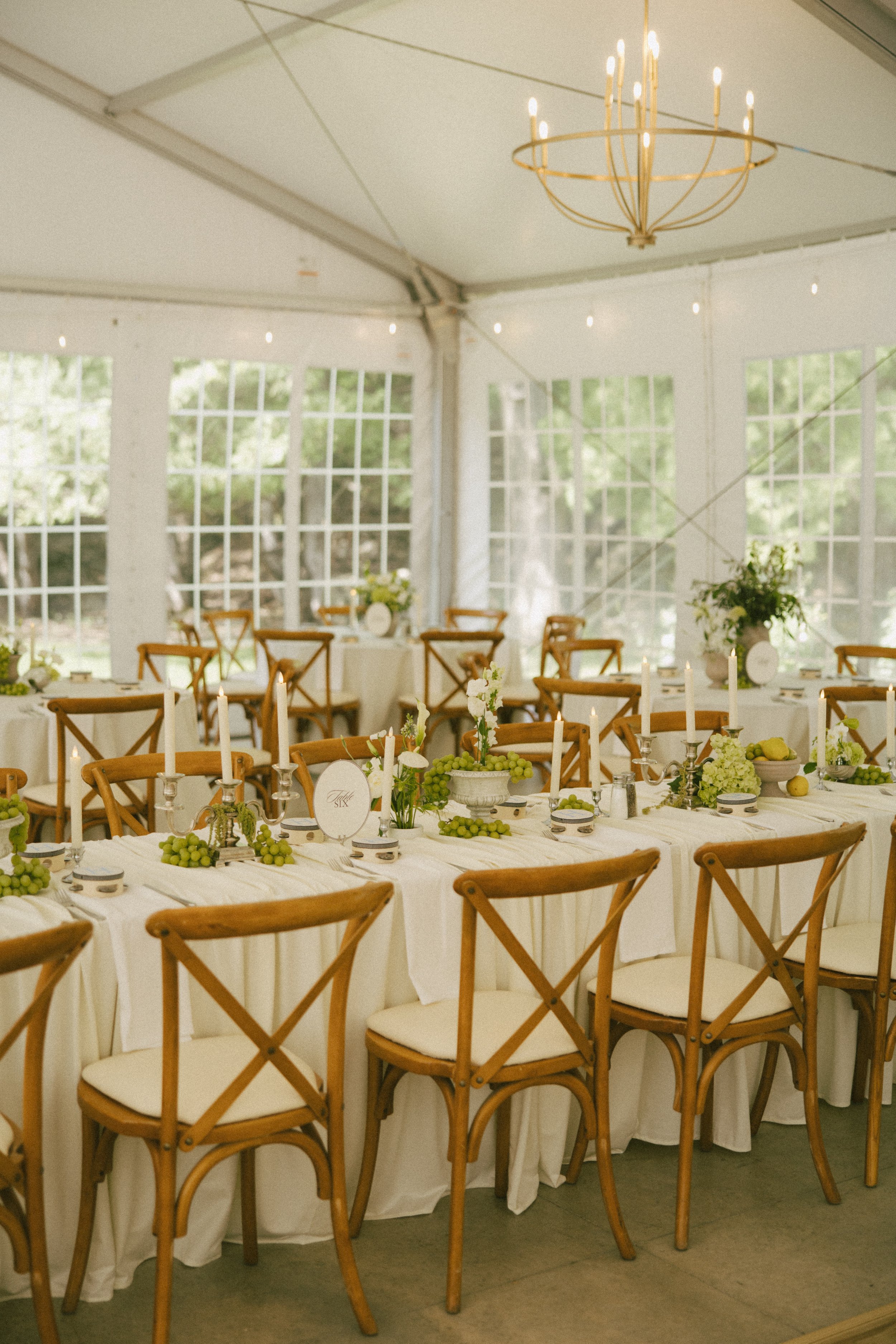 This Hilltop House wedding in Rochester, Minnesota was all about the details: airy garden-inspired florals, old-world candlelight, soft white linens, and those gorgeous little clusters of green grapes winding their way down the table.