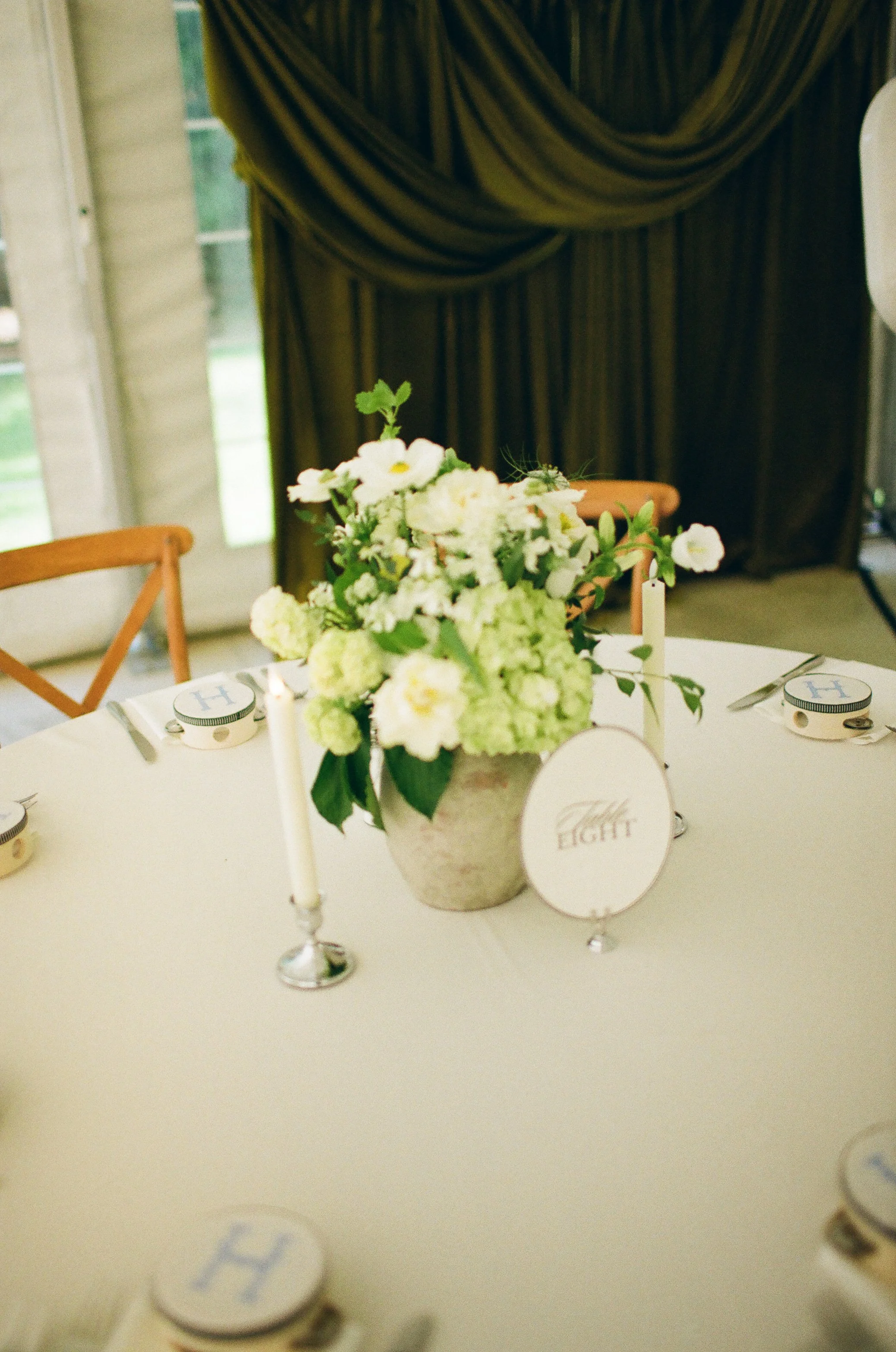 This Hilltop House wedding in Rochester, Minnesota was all about the details: airy garden-inspired florals, old-world candlelight, soft white linens, and those gorgeous little clusters of green grapes winding their way down the table.