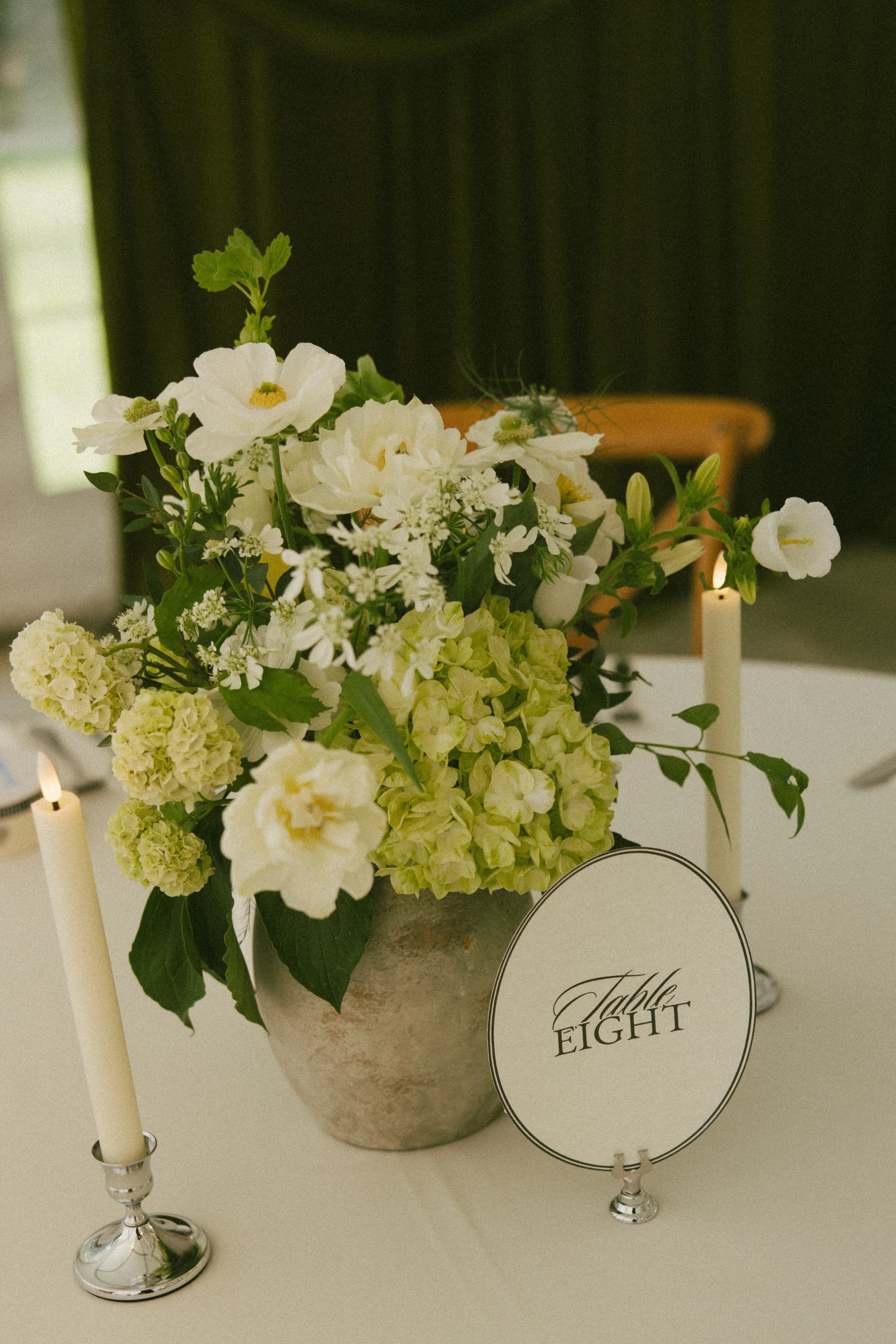 Romantic Rochester, MN wedding flowers featuring a modern white bridal bouquet, lush greenery, statement blooms, and garden-inspired ceremony florals.