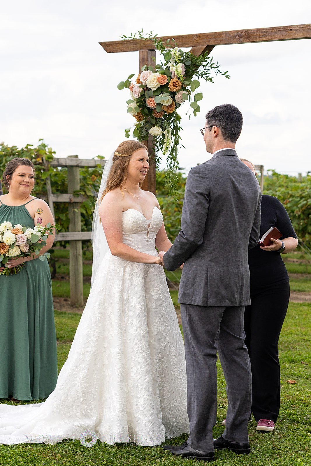 Romantic Spring Valley, MN wedding flowers screams quiet luxury - subtle statement florals on an arch at Four Daughter's Winery
