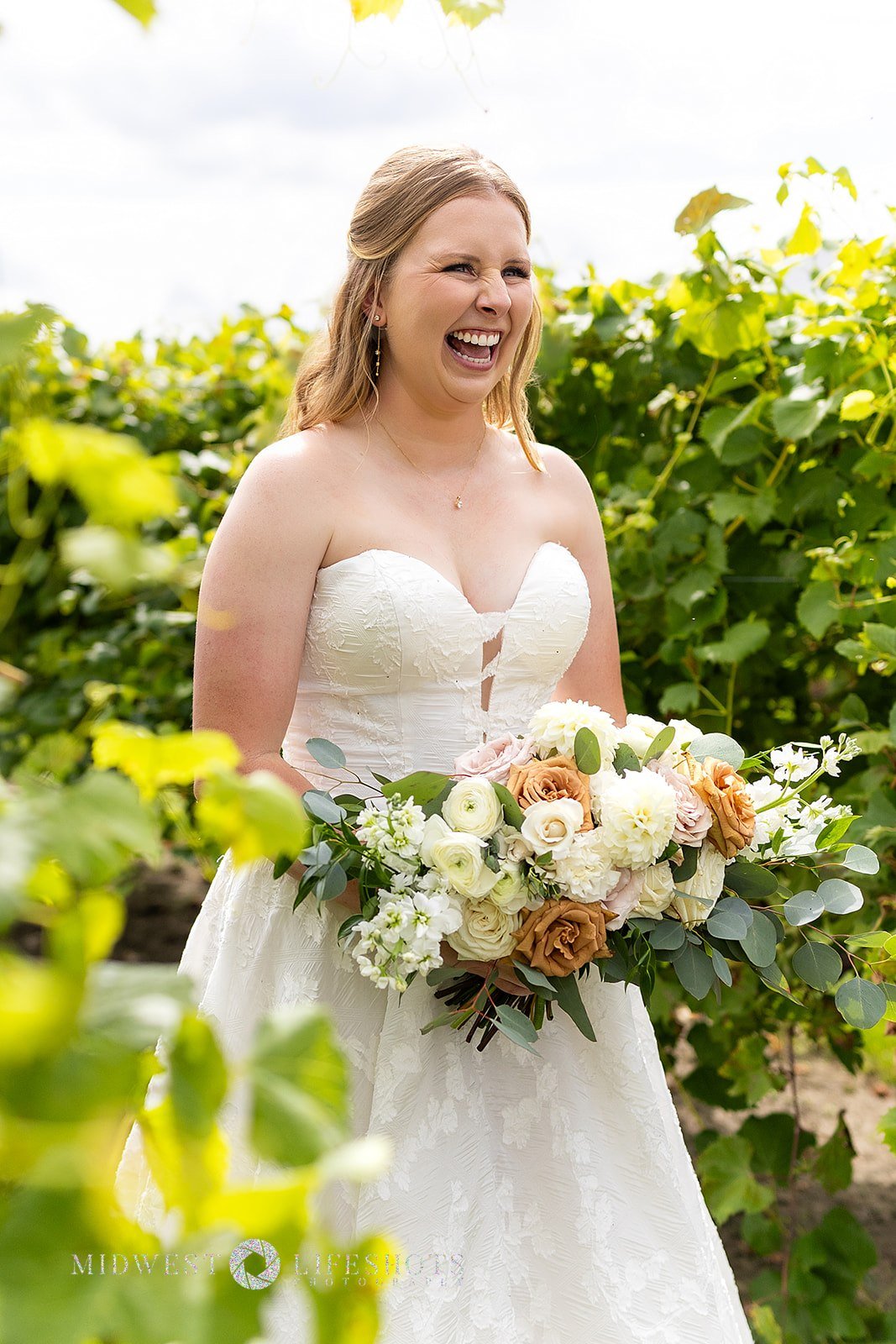 Four Daughters Vineyard & Winery wedding featuring a lush bridal bouquet in creamy whites, soft pinks, and unexpected brown blooms, with romantic wedding florals in Spring Valley, MN.