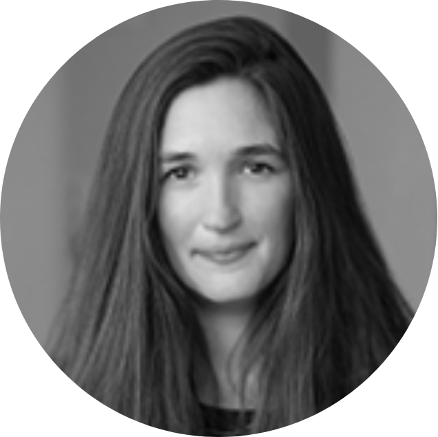 A black and white portrait of a young woman with long, straight hair, smiling softly.