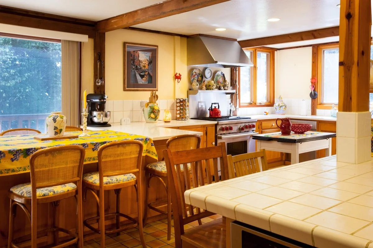 Kitchen with Wolf Range stove and oven set, two fridges, two sinks, and plenty of counter space.