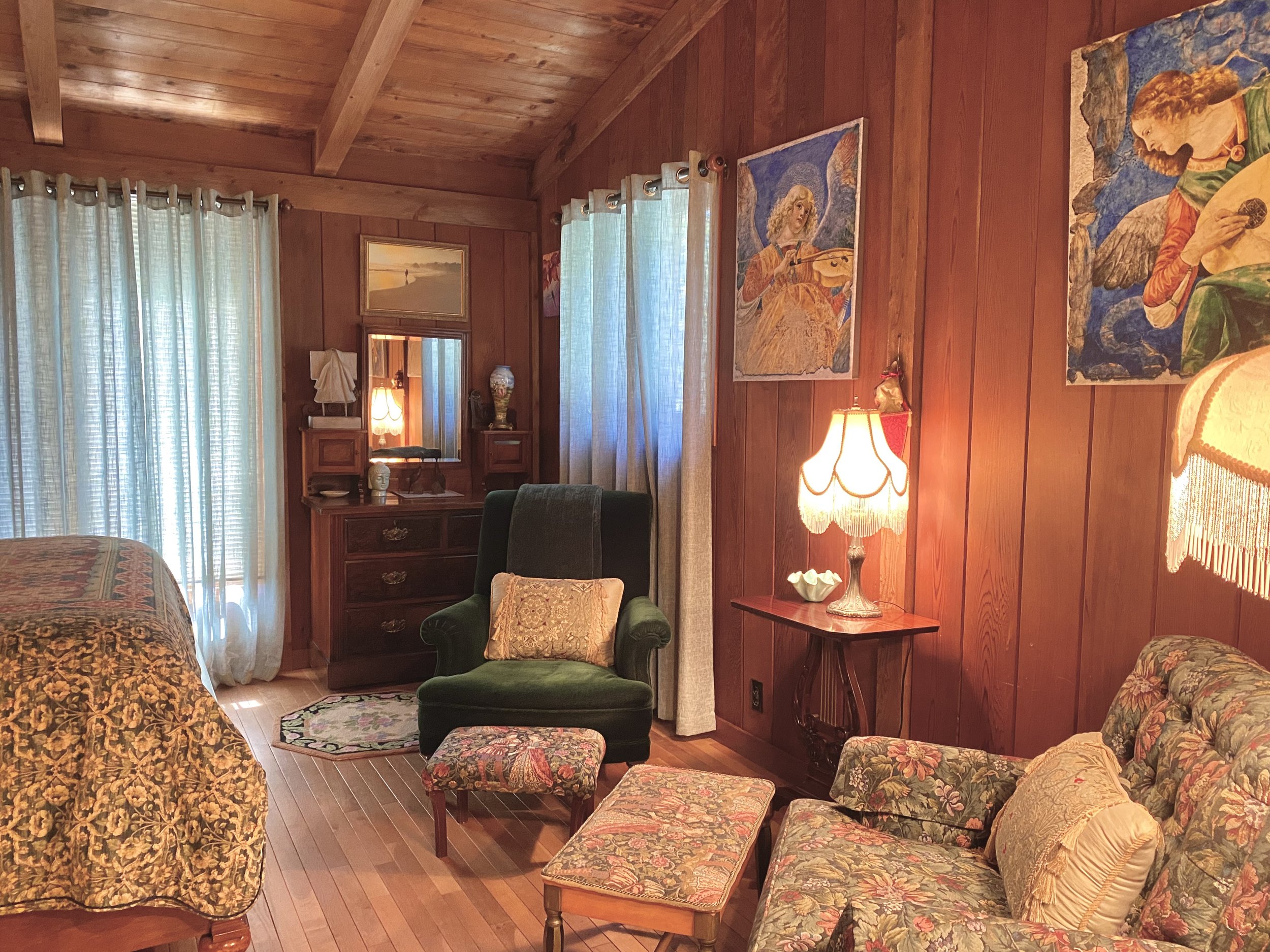 A bedroom with paintings and stunning wood interior.