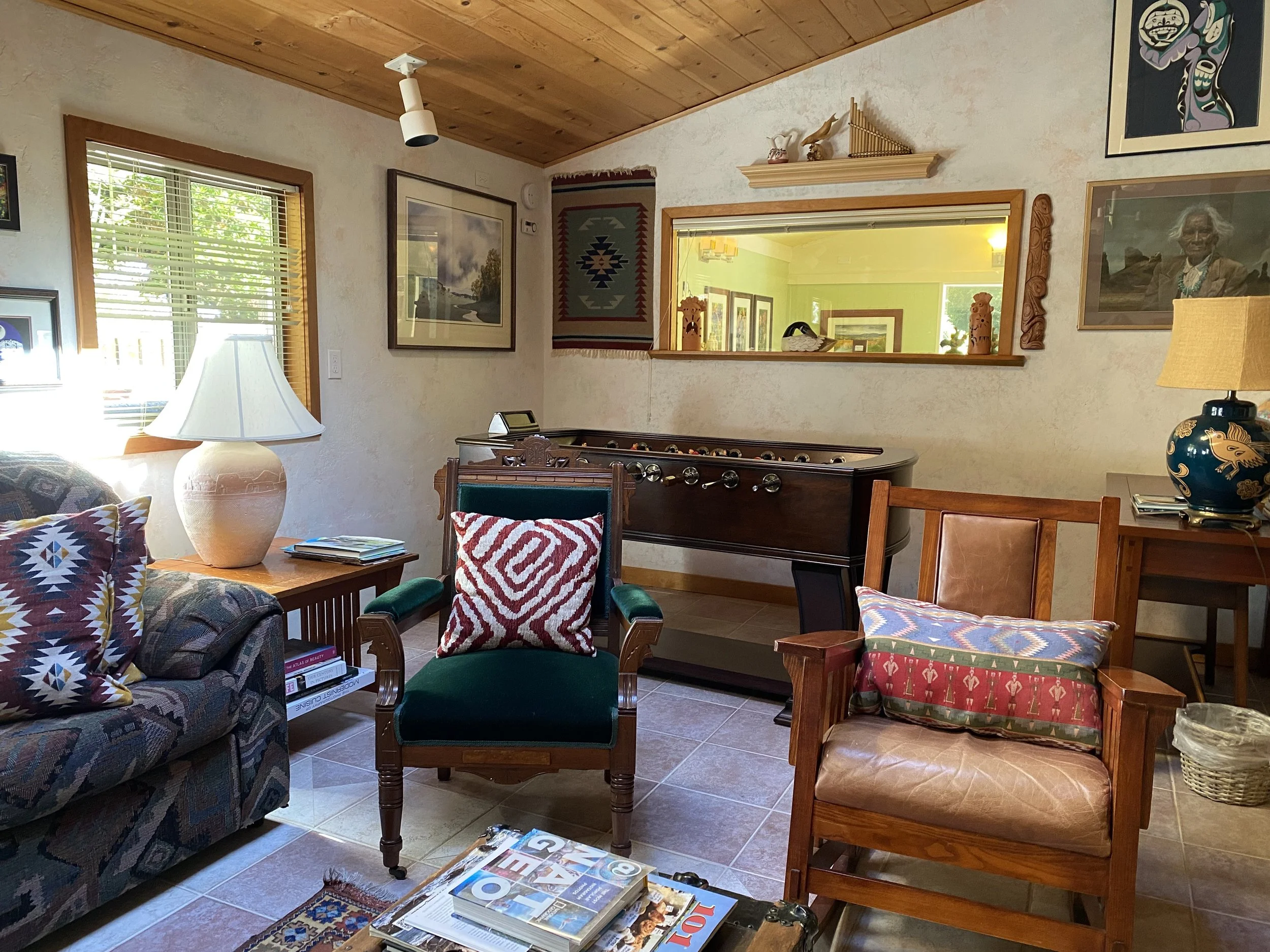 LIving Room Includes several chairs and a foosball table.