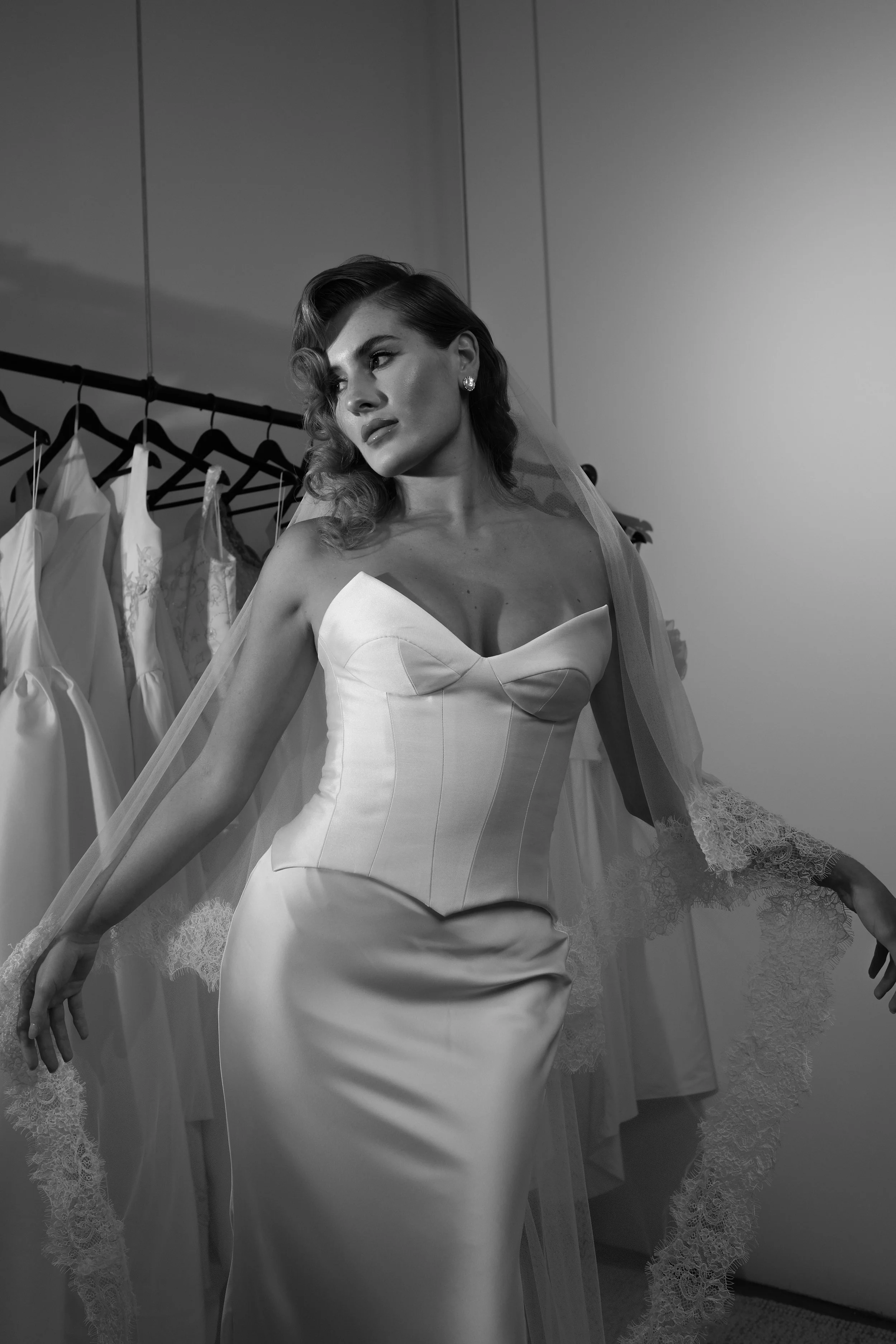 The 'Loranza' gown is a sophisticated two-piece set featuring an Italian satin skirt and a structured Mikado corset bodice. With its chic cat-eye neckline and sleek silhouette, this look strikes the perfect balance between modern elegance and timeles