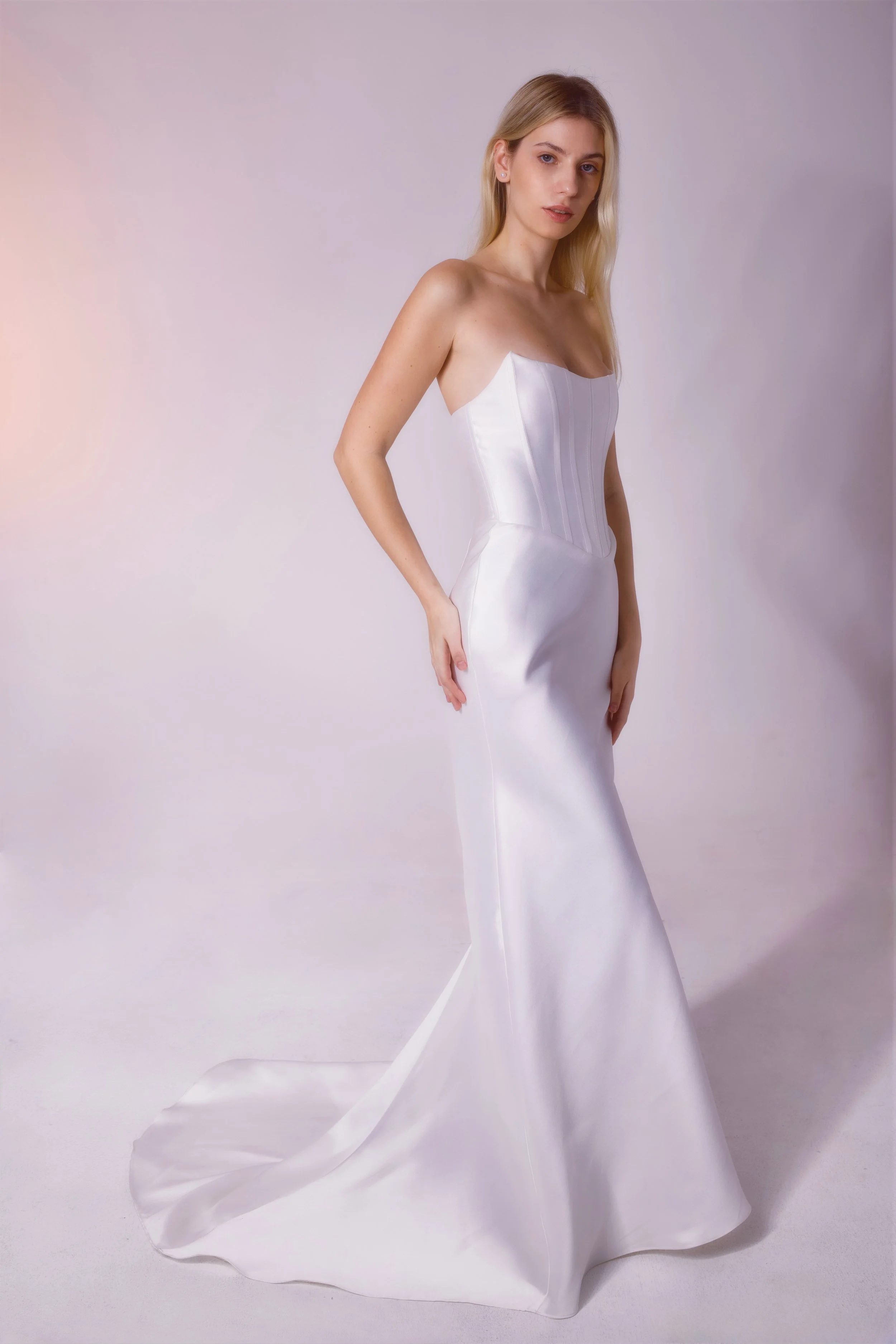 Mikado fabric dress featuring a corset-shaped top with built-in boning, cateye detailing, and a fitted skirt for a structured, elegant silhouette.