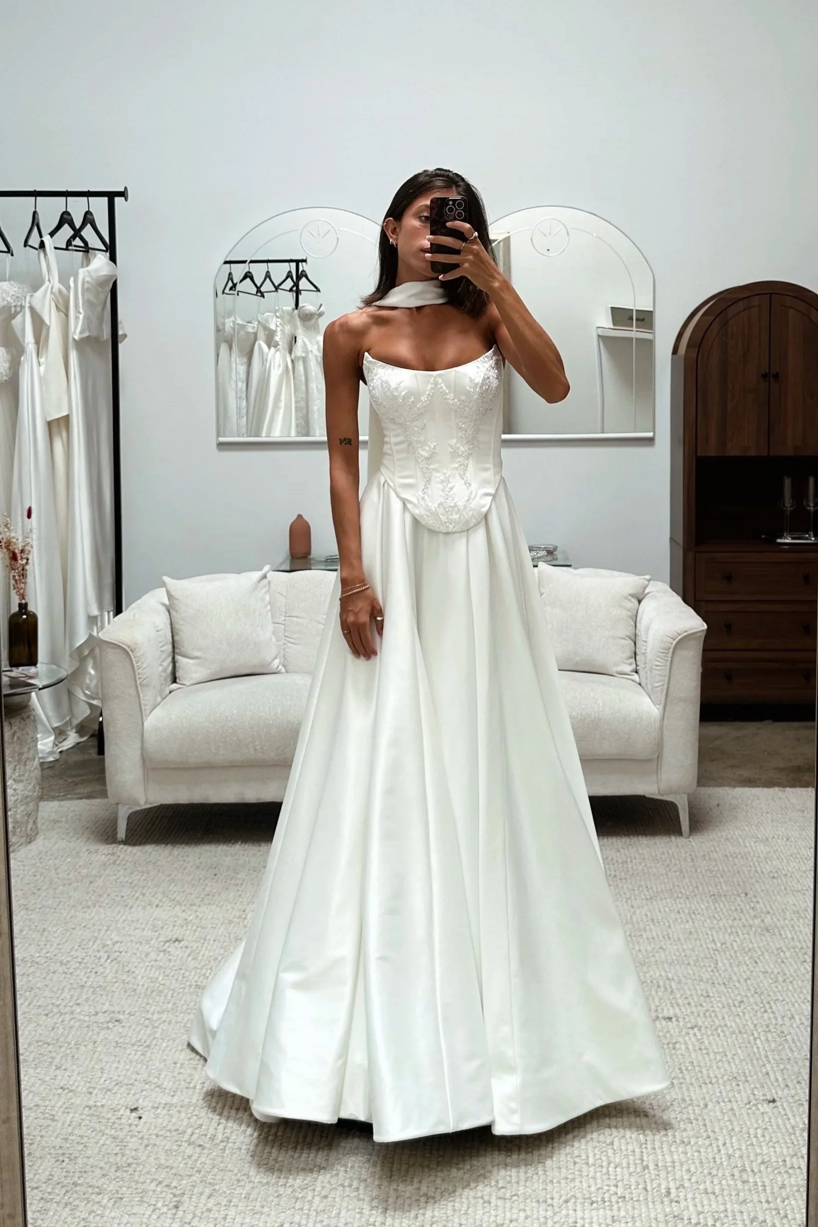 A hand-beaded corset paired with interchangeable ivory satin skirts—choose from a fitted silhouette, a classic ballgown, or a playful mini. The perfect dress to take you from your ceremony to the reception and straight into the after-party, all in on