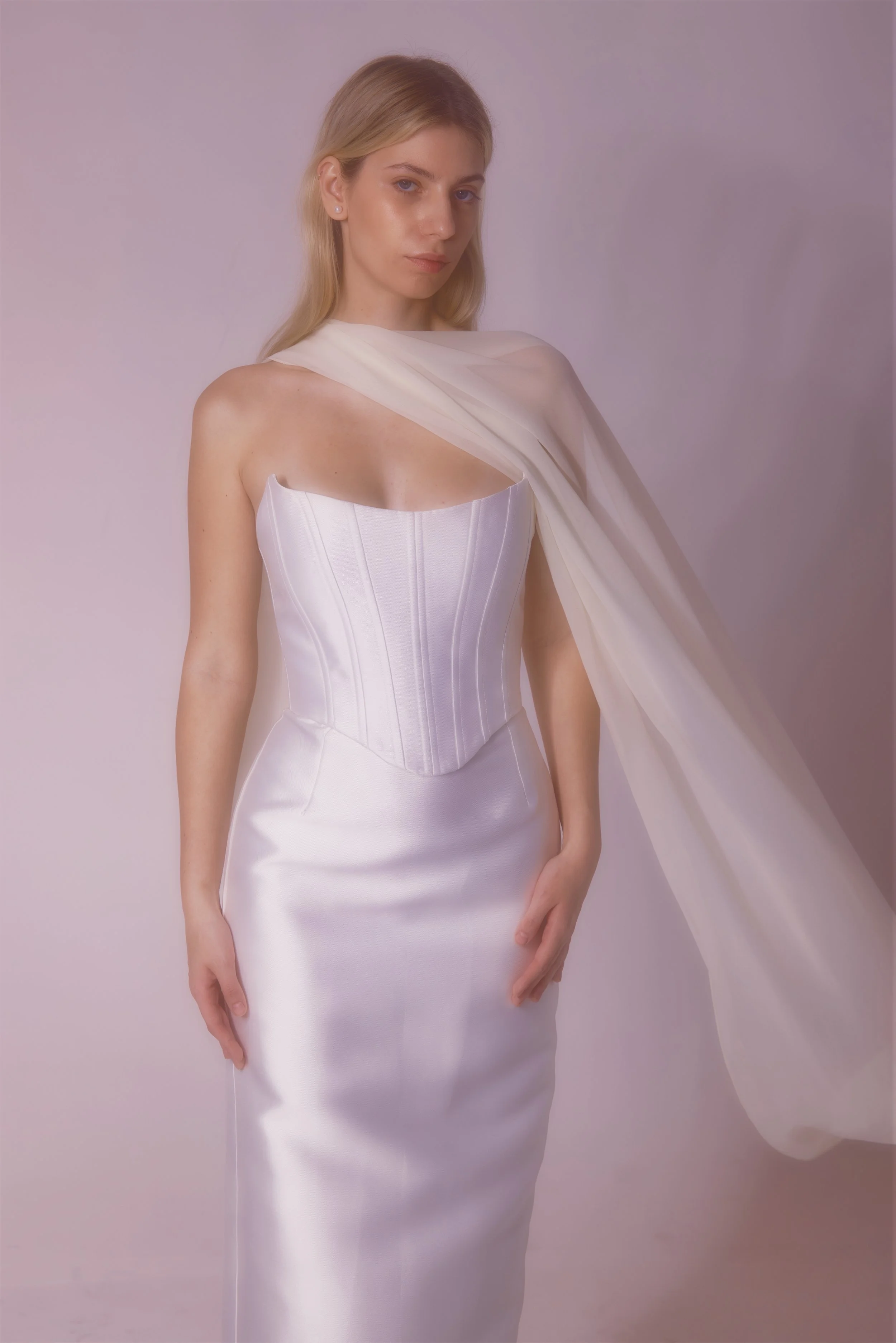 Mikado fabric dress with a corset top designed for a clean, smooth look, featuring a detachable skirt that fits neatly under the belt for versatile styling.