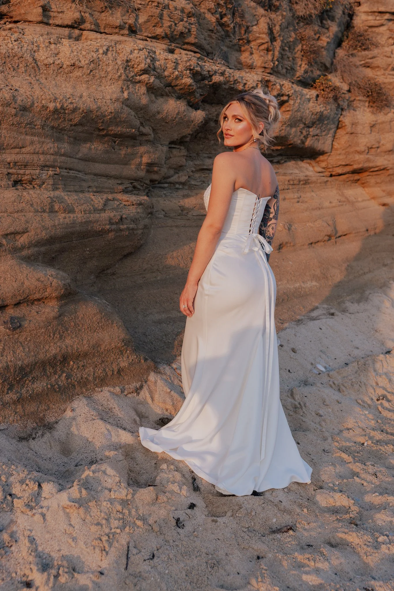 A hand-beaded corset paired with interchangeable ivory satin skirts—choose from a fitted silhouette, a classic ballgown, or a playful mini. The perfect dress to take you from your ceremony to the reception and straight into the after-party, all in on