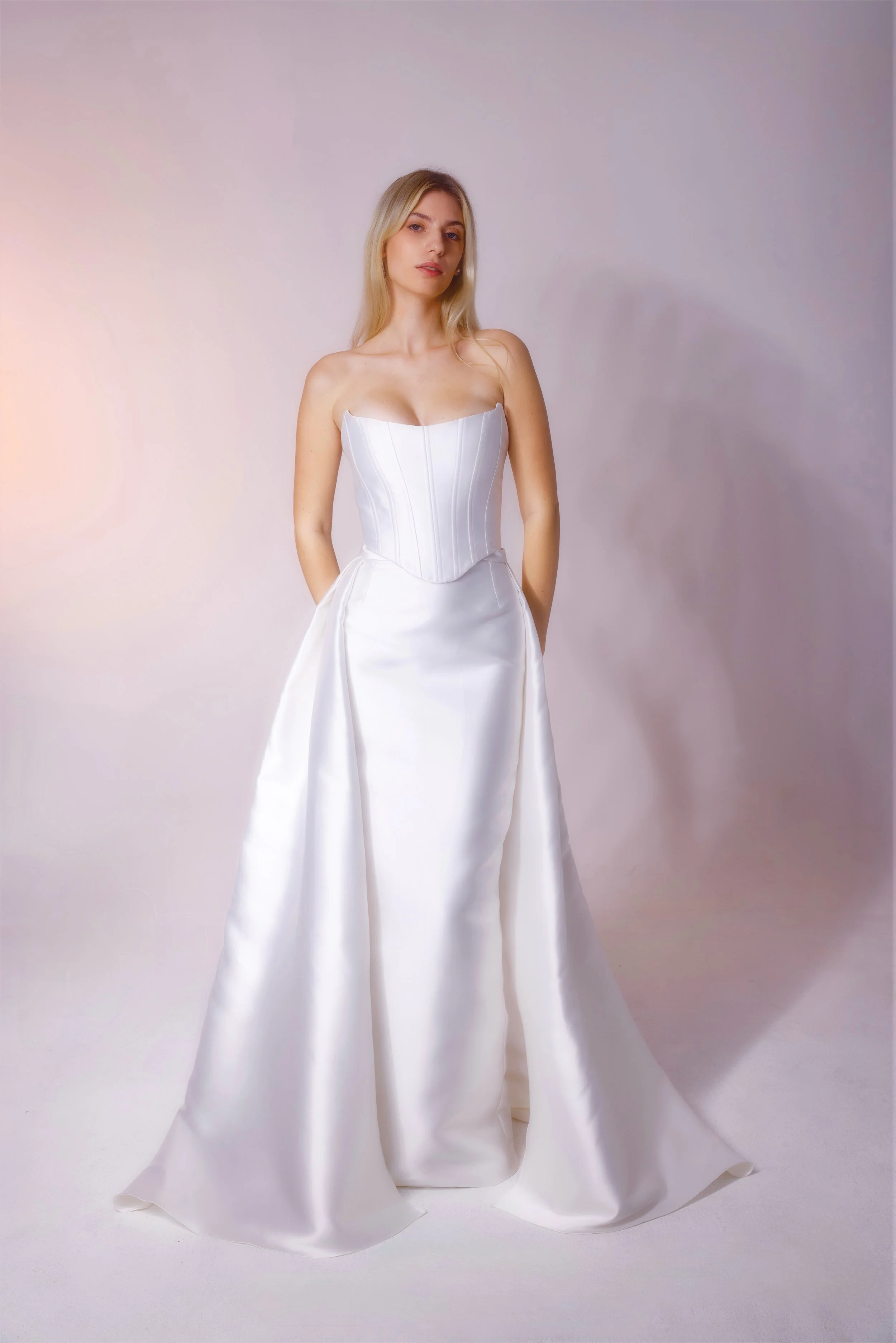 Mikado fabric dress with a corset top designed for a clean, smooth look, featuring a detachable skirt that fits neatly under the belt for versatile styling.