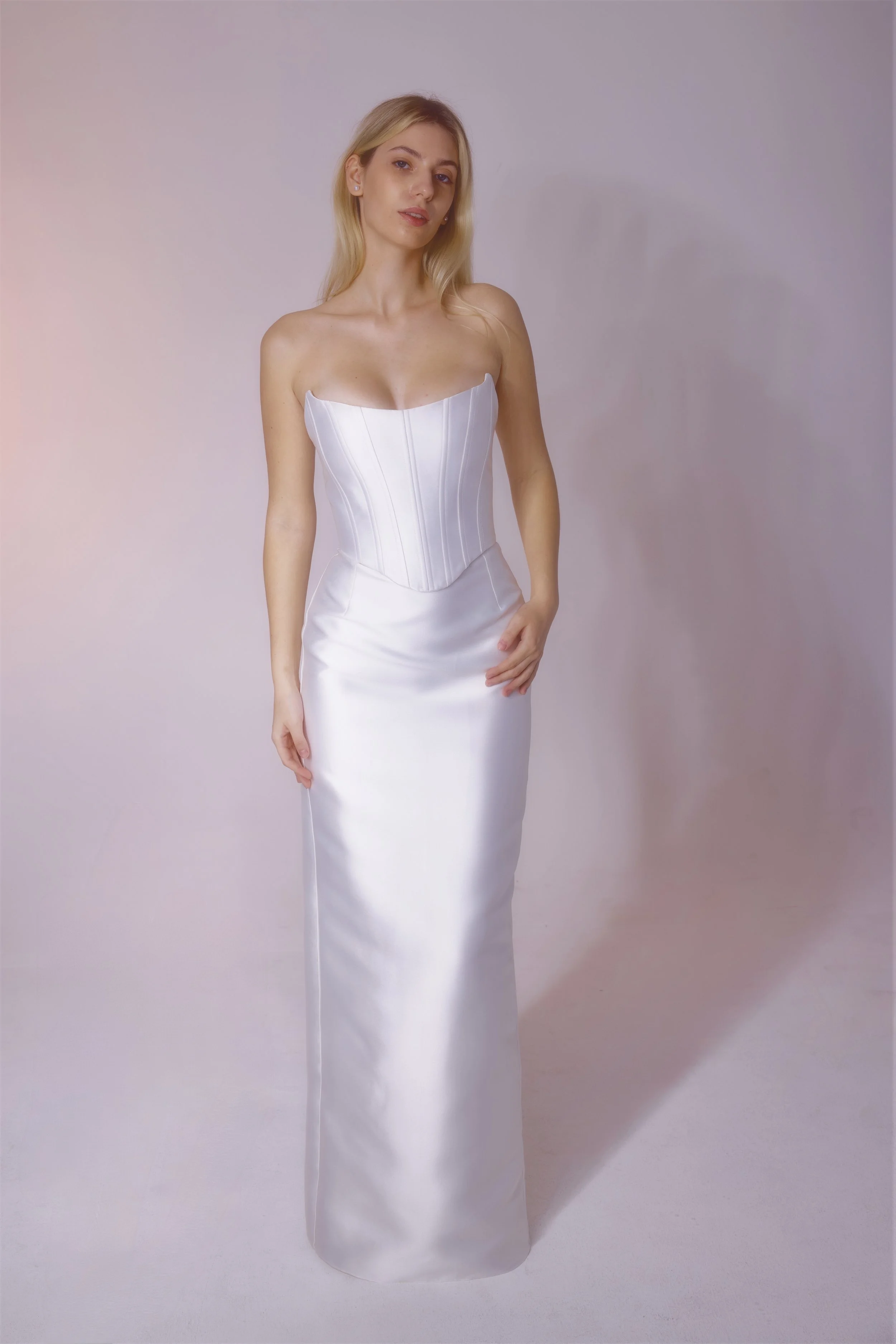 Mikado fabric dress with a corset top designed for a clean, smooth look, featuring a detachable skirt that fits neatly under the belt for versatile styling.