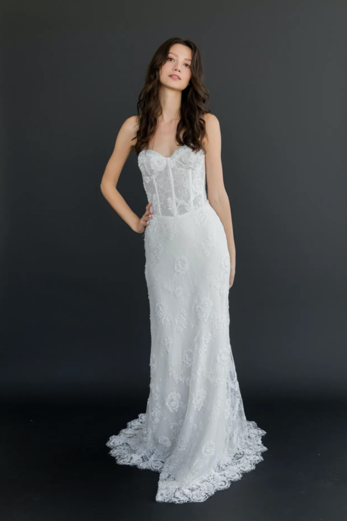 Gown "Zephyr" is crafted from beaded Chantilly lace and soft georgette, offering a fitted silhouette that feels both sexy and sophisticated. The strapless bodice features structured boning for added support, while subtle sparkle and intricate lace de