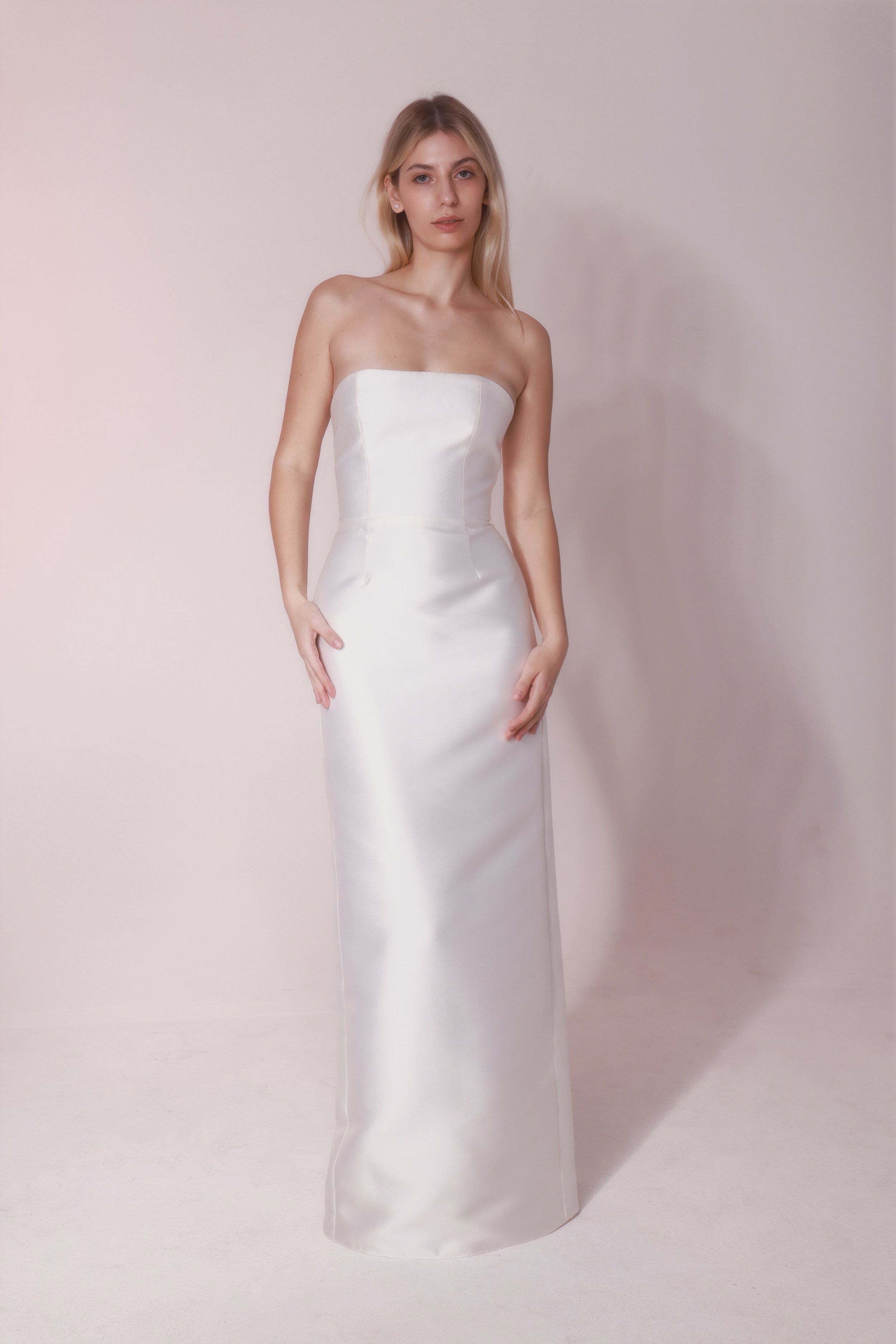 Mikado fabric with a subtle shine, designed with clean lines and a straight silhouette. Finished with a detachable train for an elegant, versatile look.