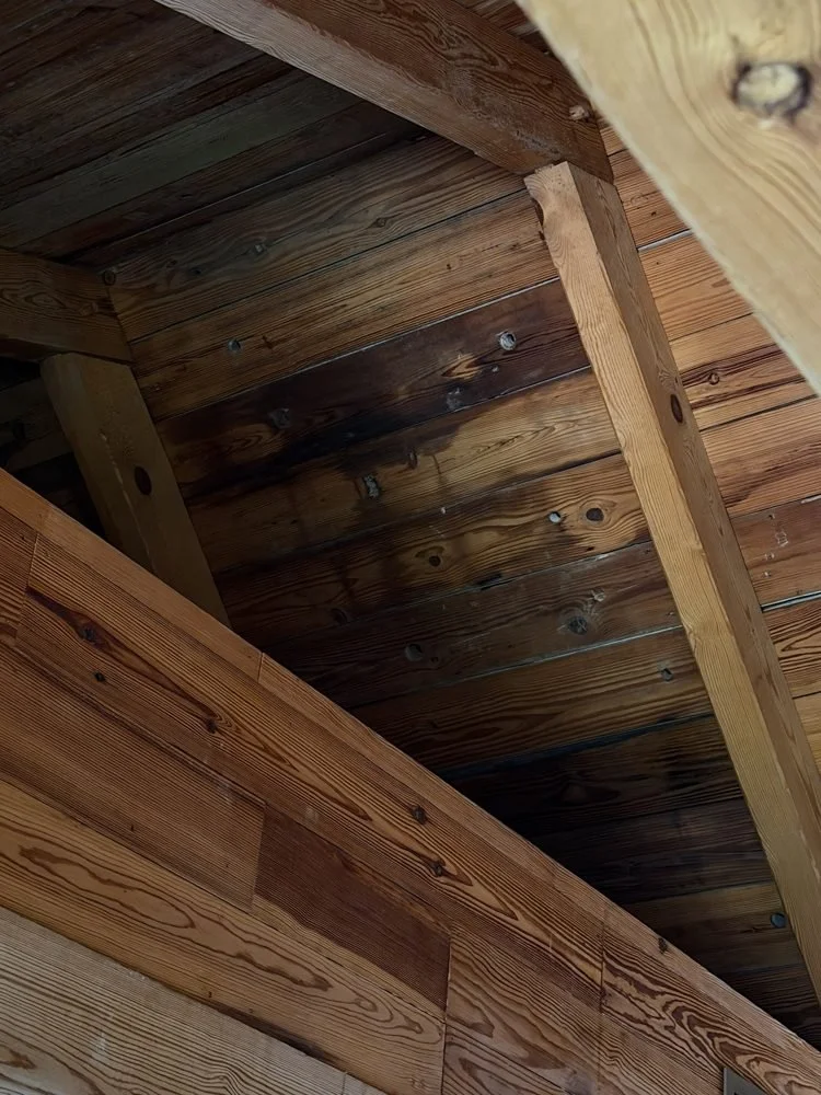 Then you look up close. Dark water stains on the ceiling boards.