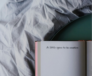 open journal on soft bedding with text “a little space to be creative,” representing creative living and mindful self-expression