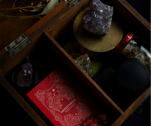 beginner witchcraft tools including crystals, herbs, and ritual items in a wooden box for spiritual practice