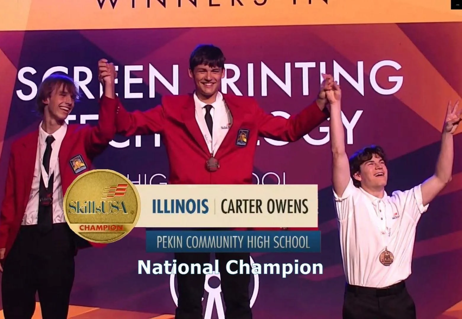Three young men on a stage, celebrating a win at a skills competition. The man in the middle, Carter Owens from Pekin Community High School in Illinois, is holding a medal and raising his arms in victory, with his hand clasped with the man on the right. The man on the right is wearing a white shirt and a bronze medal, and the man on the left is wearing a red jacket and a black tie. The backdrop features the words 'Winners in Screen Printing Technology' and the SkillsUSA logo.