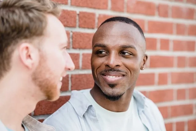 Two men partners smiling at each other