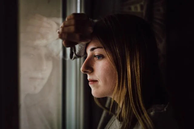 a woman looking out a window
