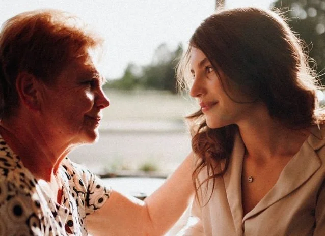 A mother and daughter comforting each other