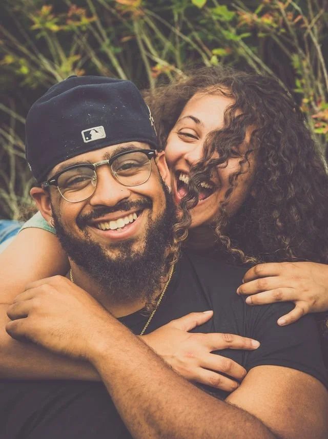 A happy couple hugging outside